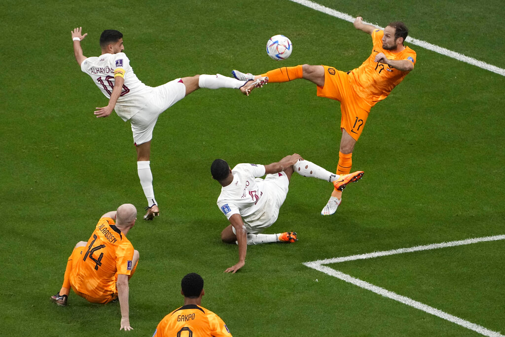 Daley Blind of the Netherlands (right) challenges for the ball with Qatar’s Hassan Al-Haydos during the World Cup Group A match between the Netherlands and Qatar at the Al Bayt Stadium, November 29, 2022