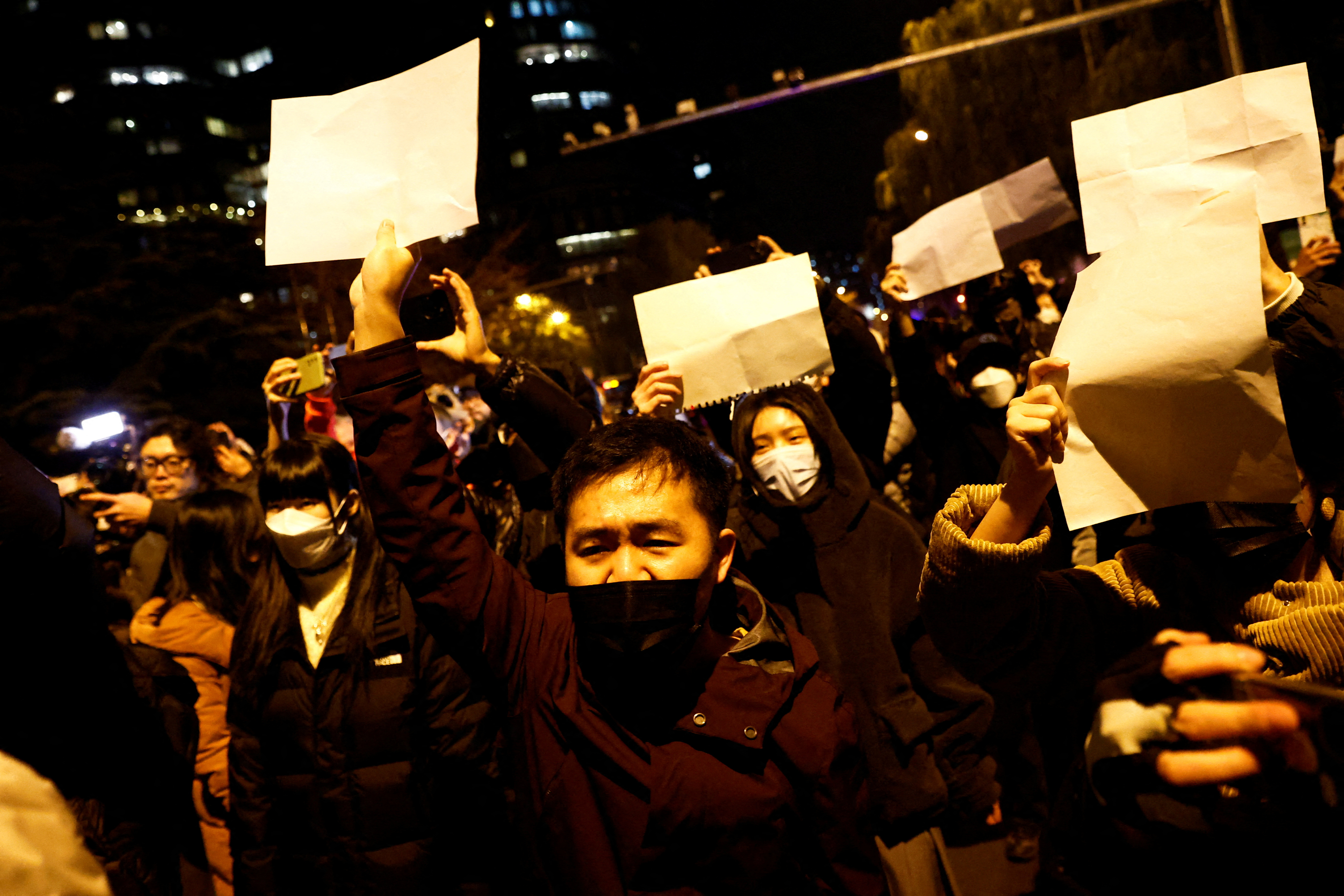 People demonstrate against coronavirus restrictions in the city of Urumqi