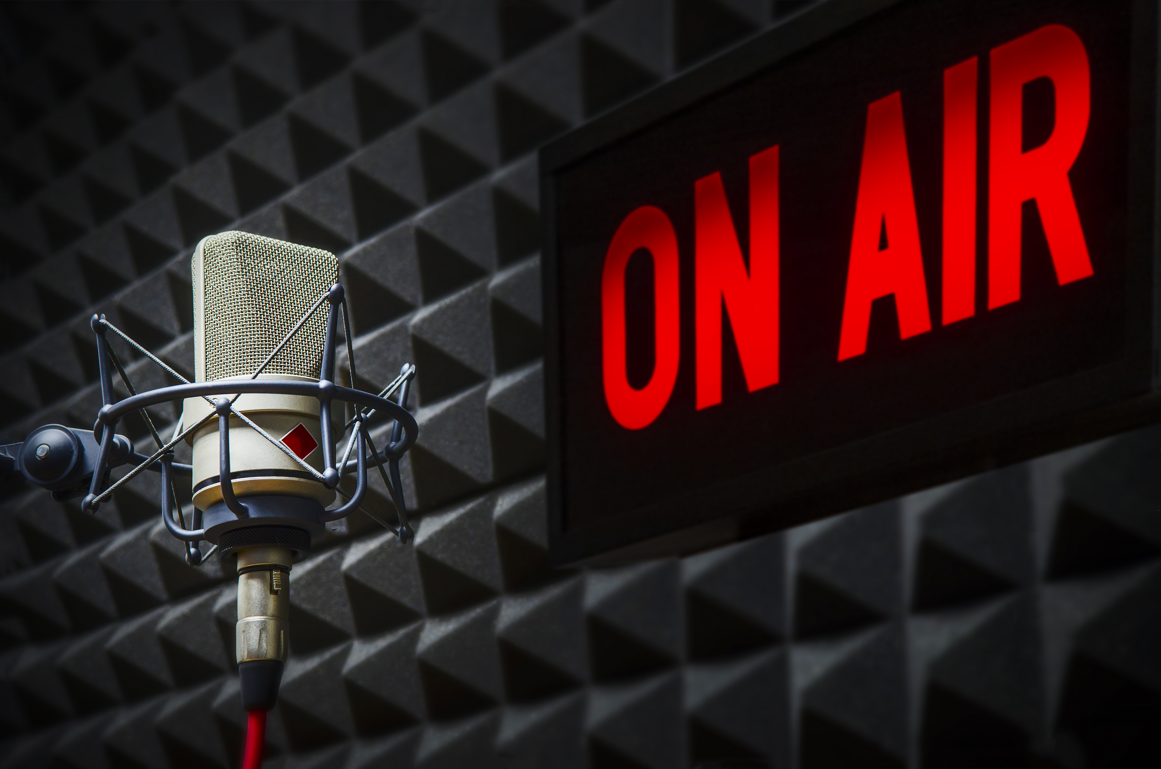 On air sign and microphone in a radio studio.