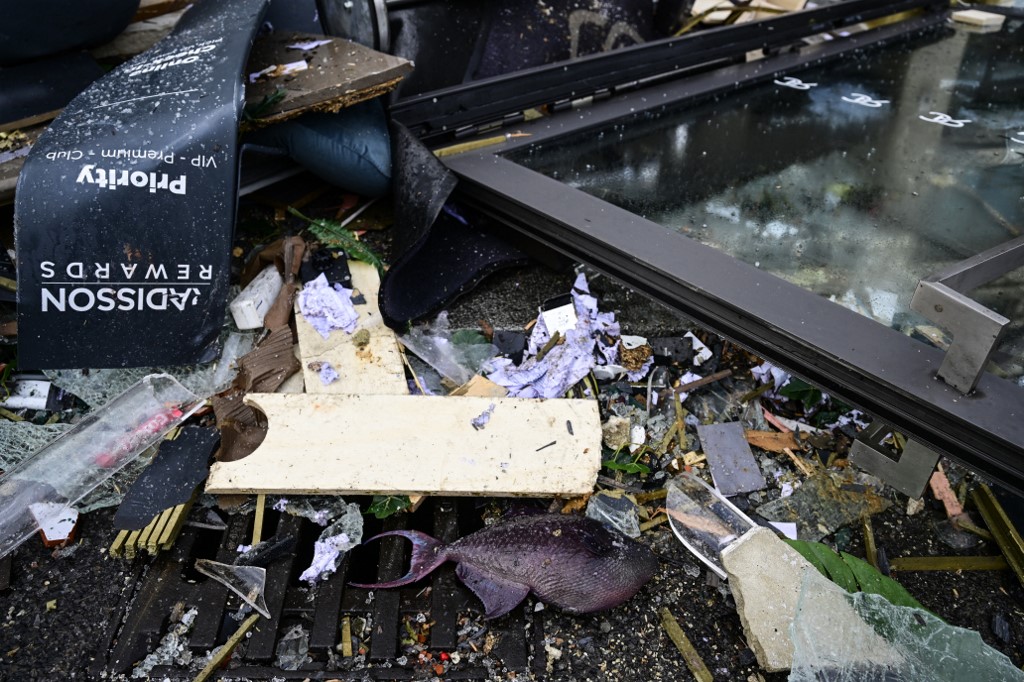 A dead fish lies in the debris in front of the Radisson Blu hotel, where a huge aquarium located in the hotel's lobby burst on December 16, 2022 in Berlin