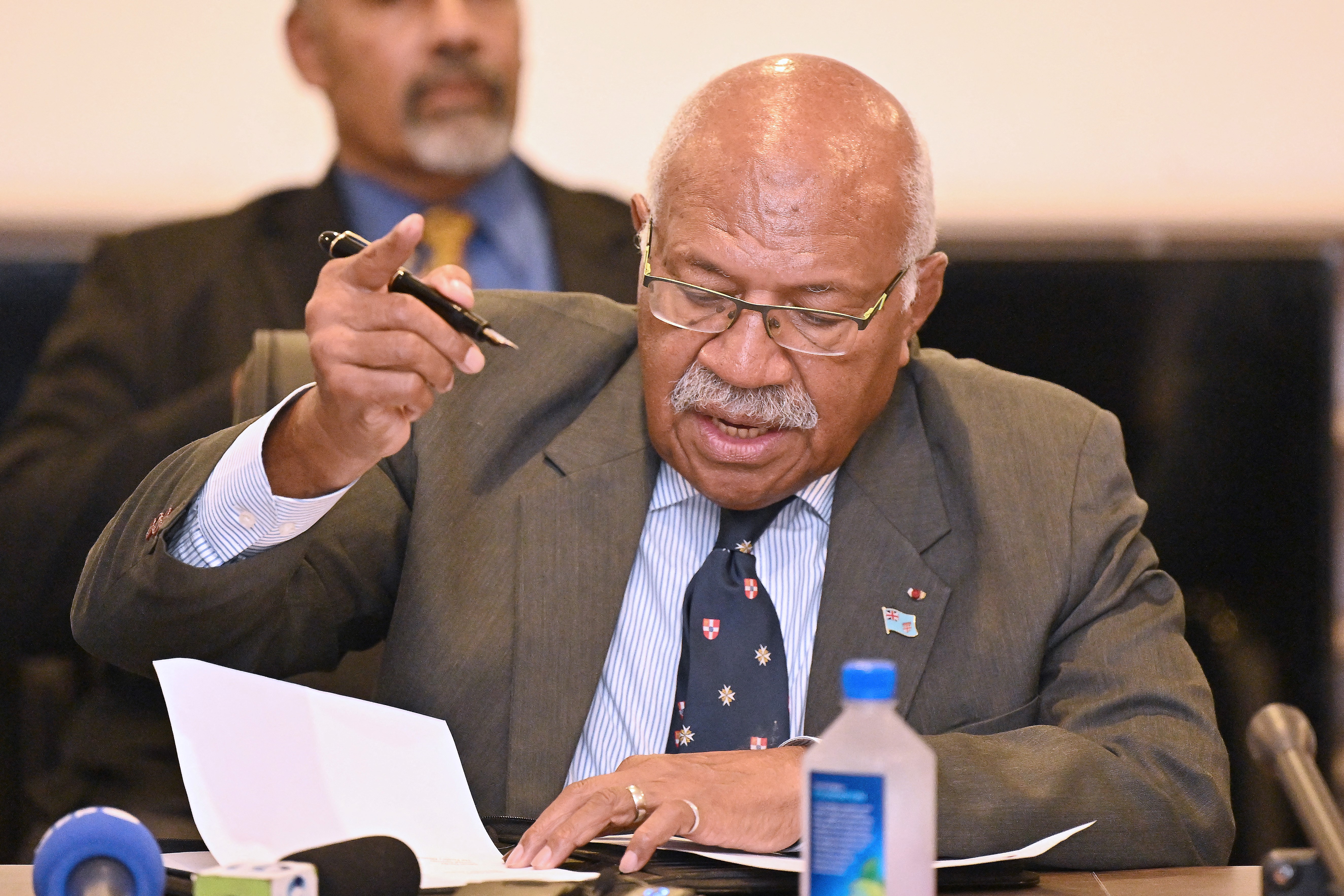 People’s Alliance Party leader Sitiveni Rabuka signs a document of an agreement to form a new government with coalition partners in Suva on December 20, 2022
