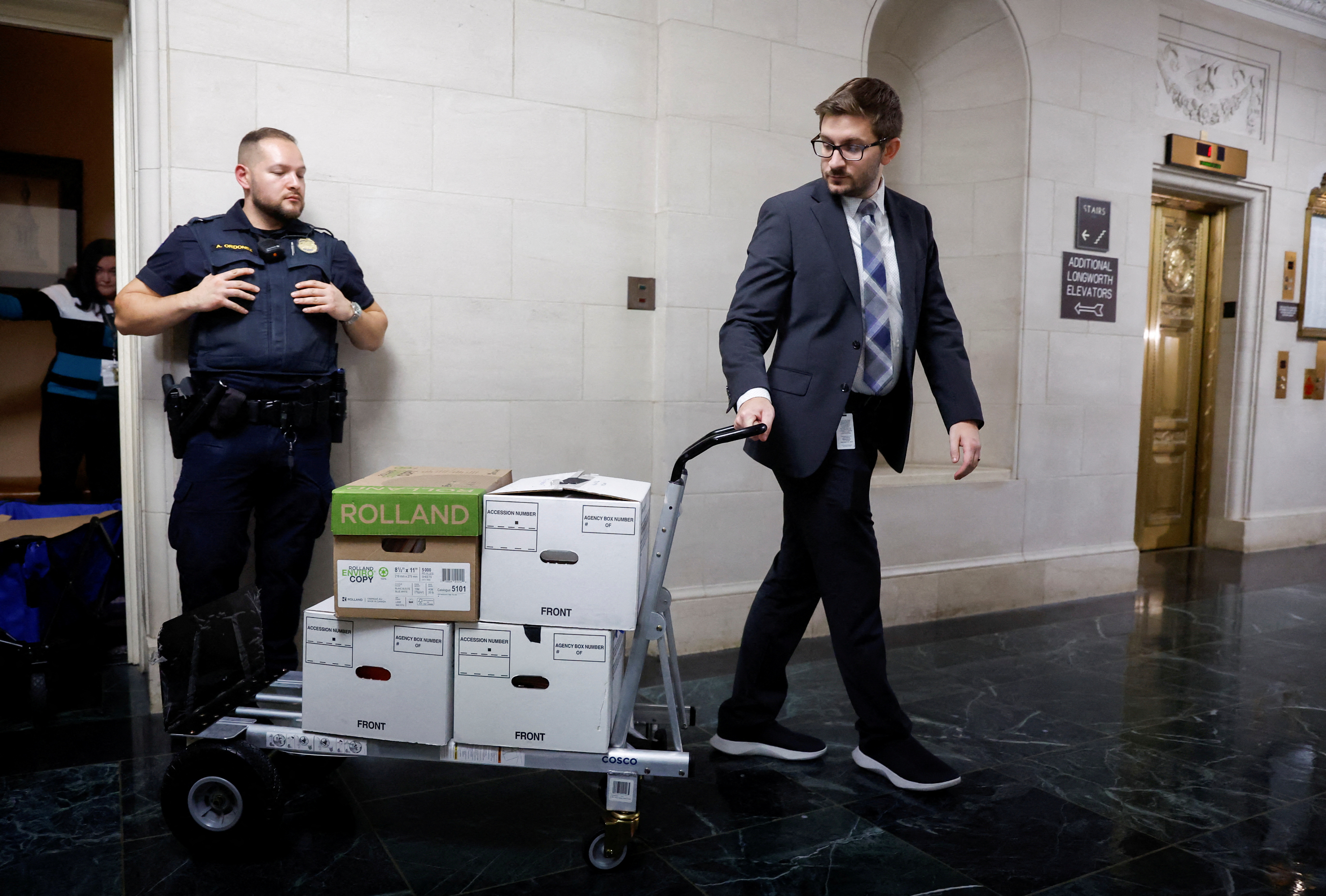 US House Ways and Means Committee staff members transport boxes of documents after a committee meeting to discuss former President Donald Trump’s tax returns on Capitol Hill in Washington, DC