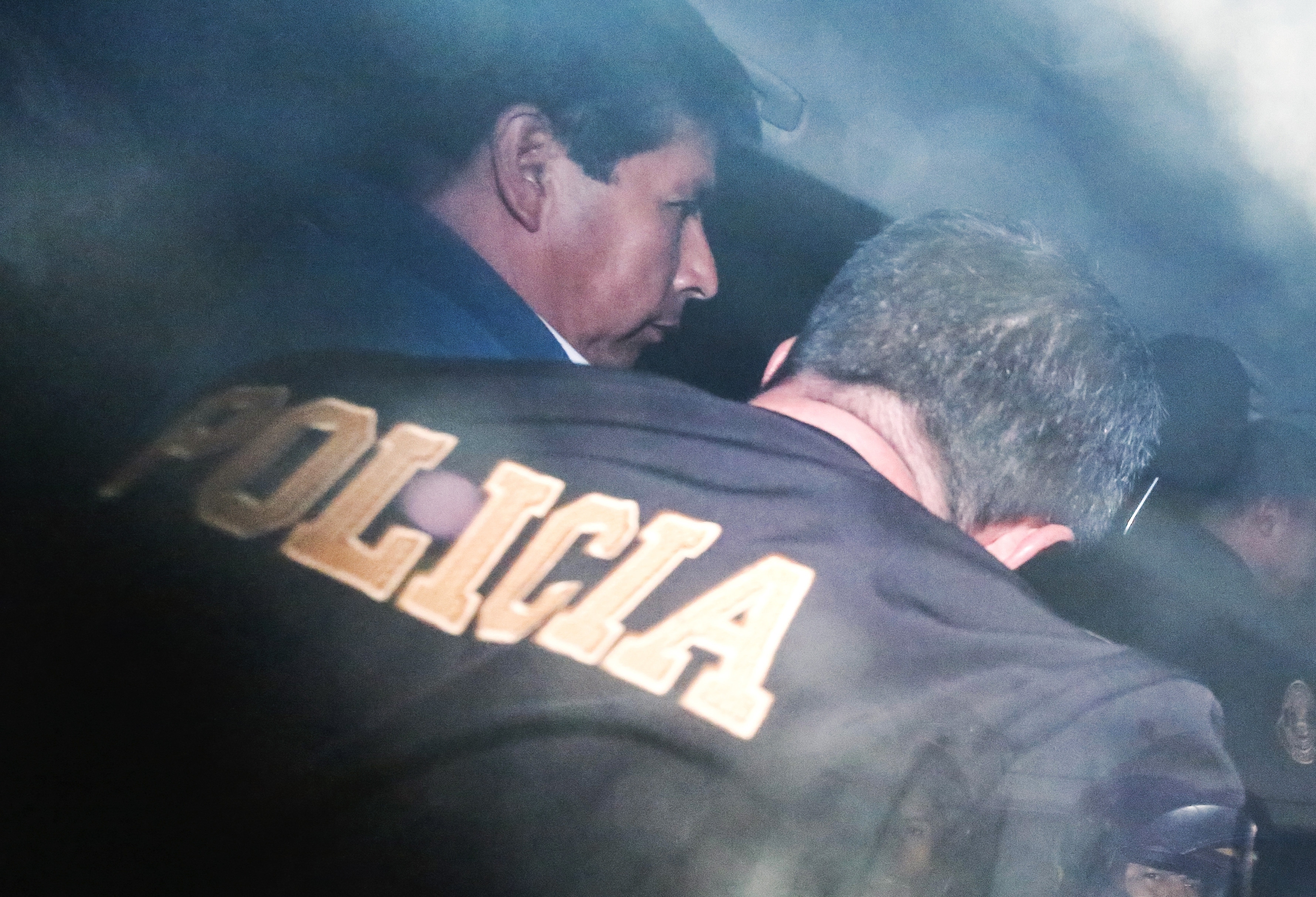 Peru's removed President Pedro Castillo is escorted by police at the police station where he is being held in Lima, Peru, December 7, 2022