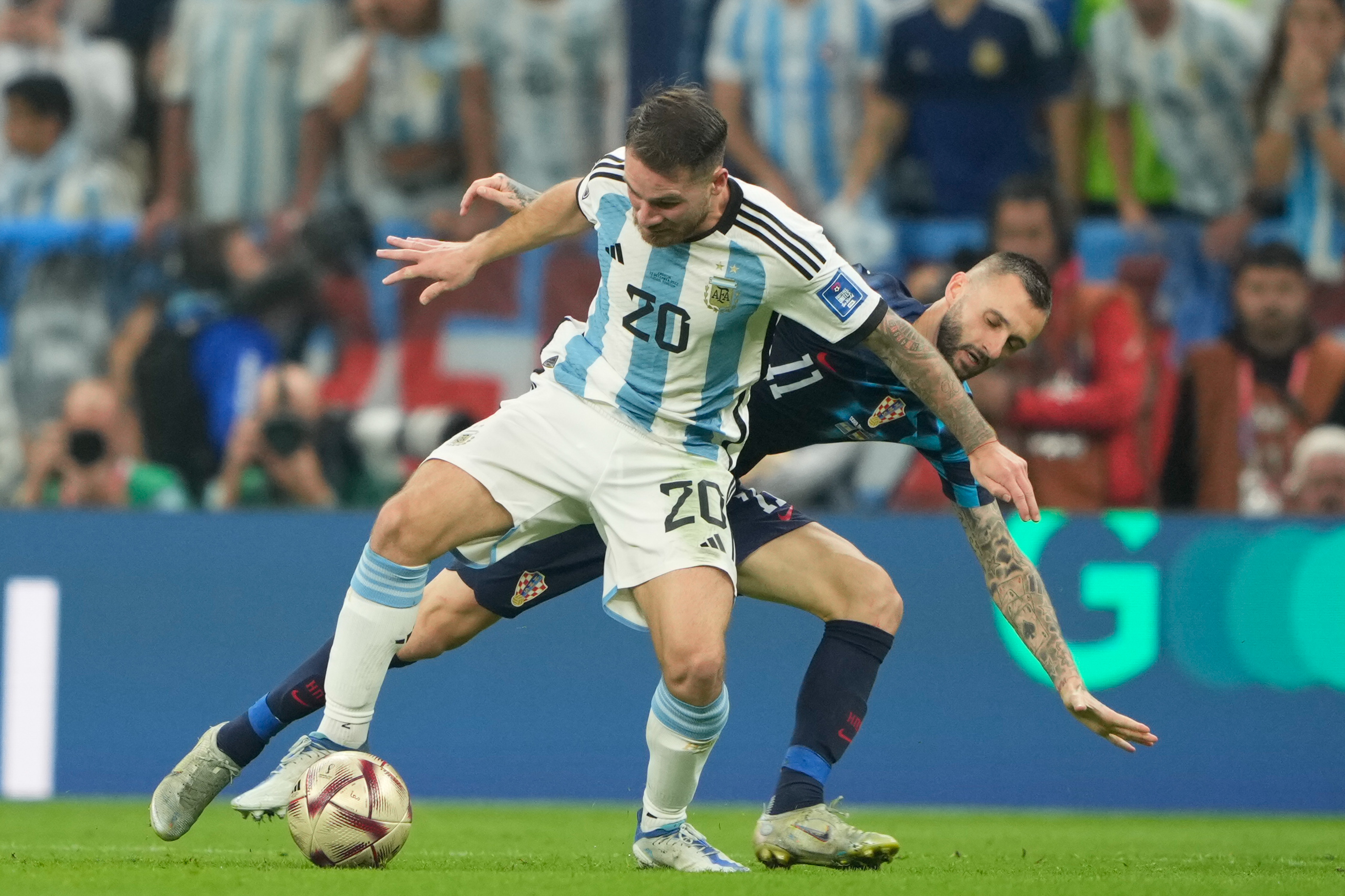 Marcelo Brozovic (R) tackles Argentina’s Alexis MacAllister at the FIFA World Cup 2022, December 13, Lusail Stadium