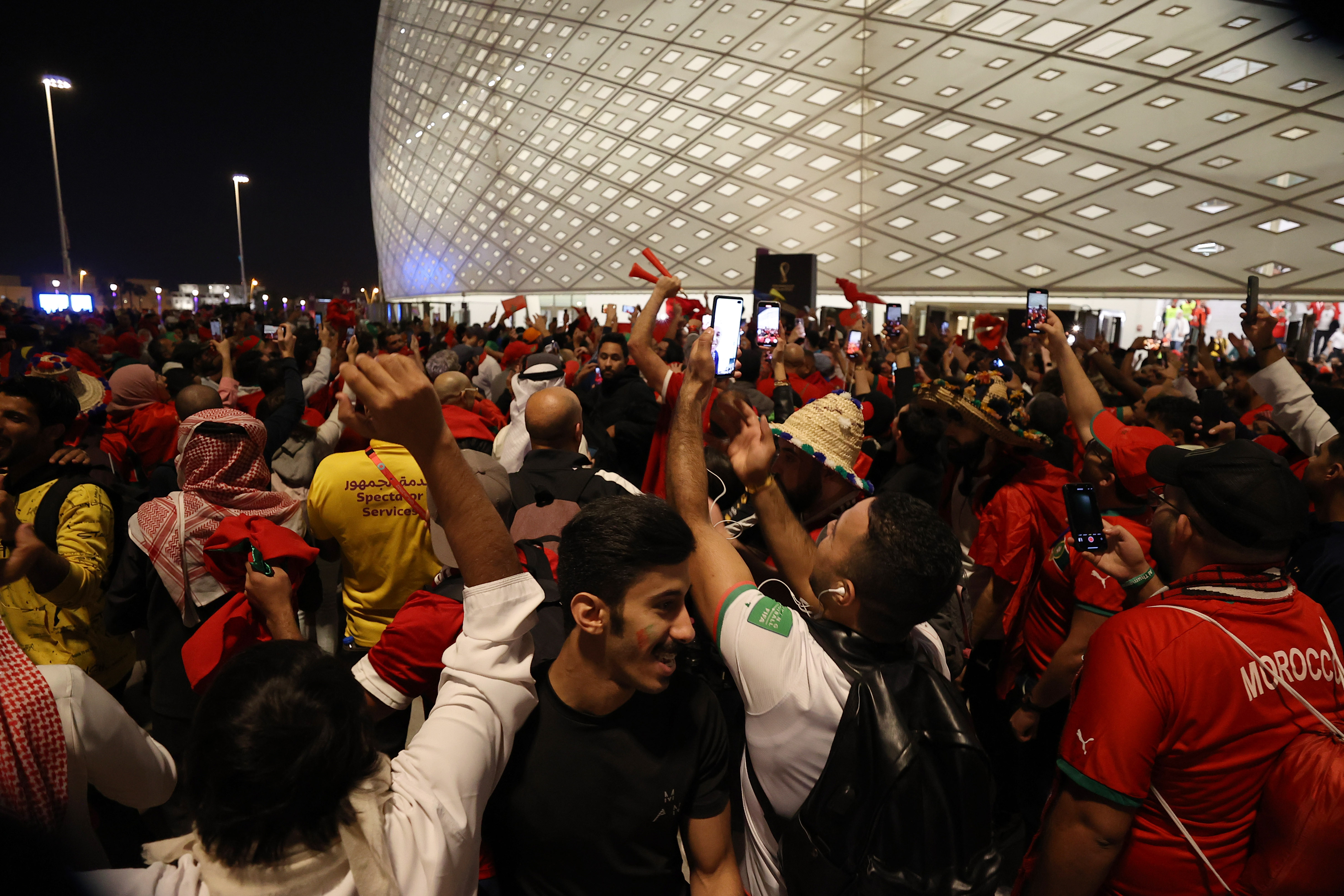 Fans celebrate outside Al Thumama Stadium after the match