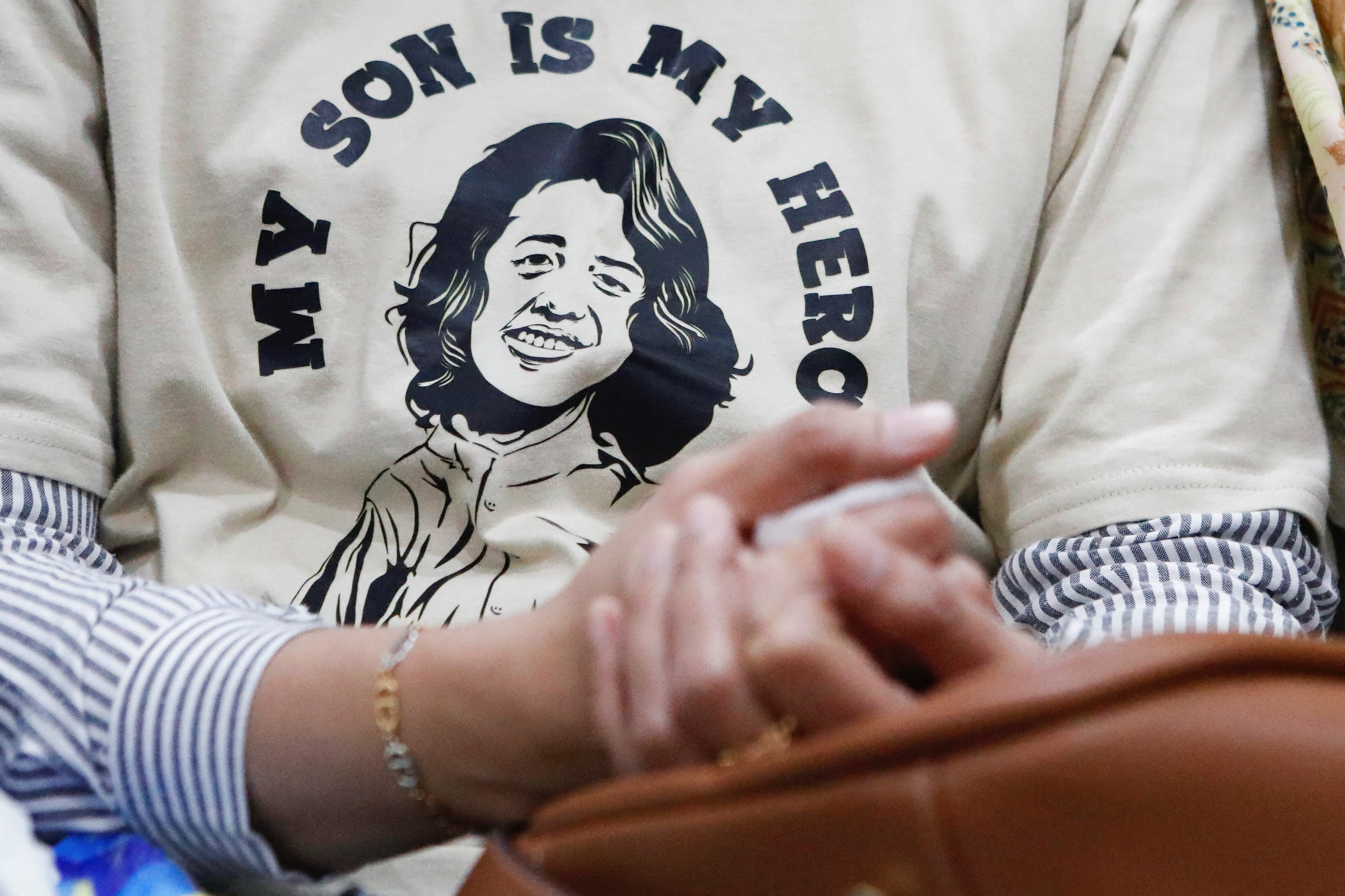 Safitri Puspa, 42, the mother of an acute kidney injury (AKI) victim, wears a t-shirt depicting her son Panghegar Bhumi, 8, as she attends a preliminary hearing for a class-action lawsuit filed against the Indonesian government and drug companies for allowing the sale of tainted cough syrup at the court in Jakarta, Indonesia, January 17, 2023. REUTERS/Ajeng Dinar Ulfiana