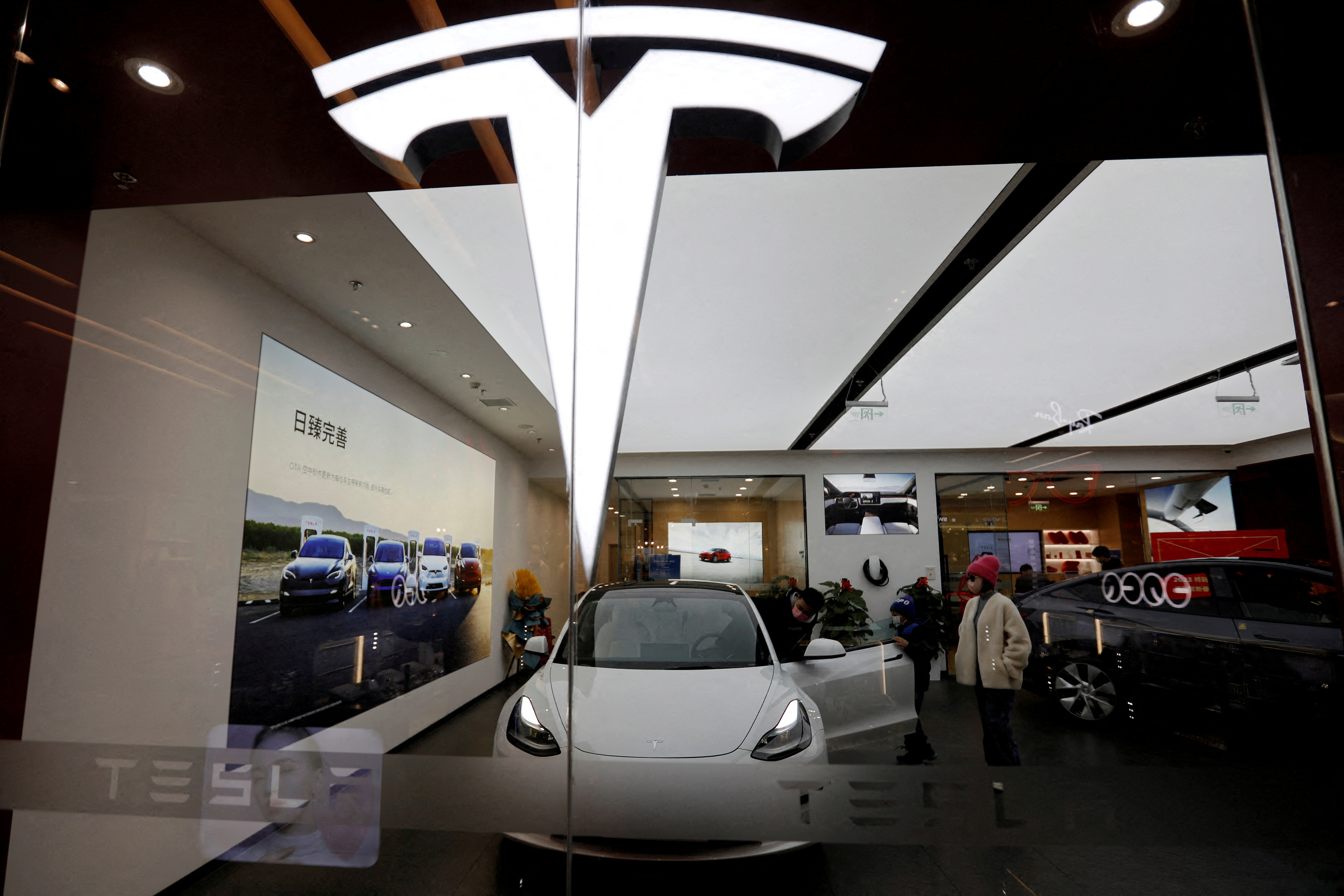 The Tesla logo on a glass window.