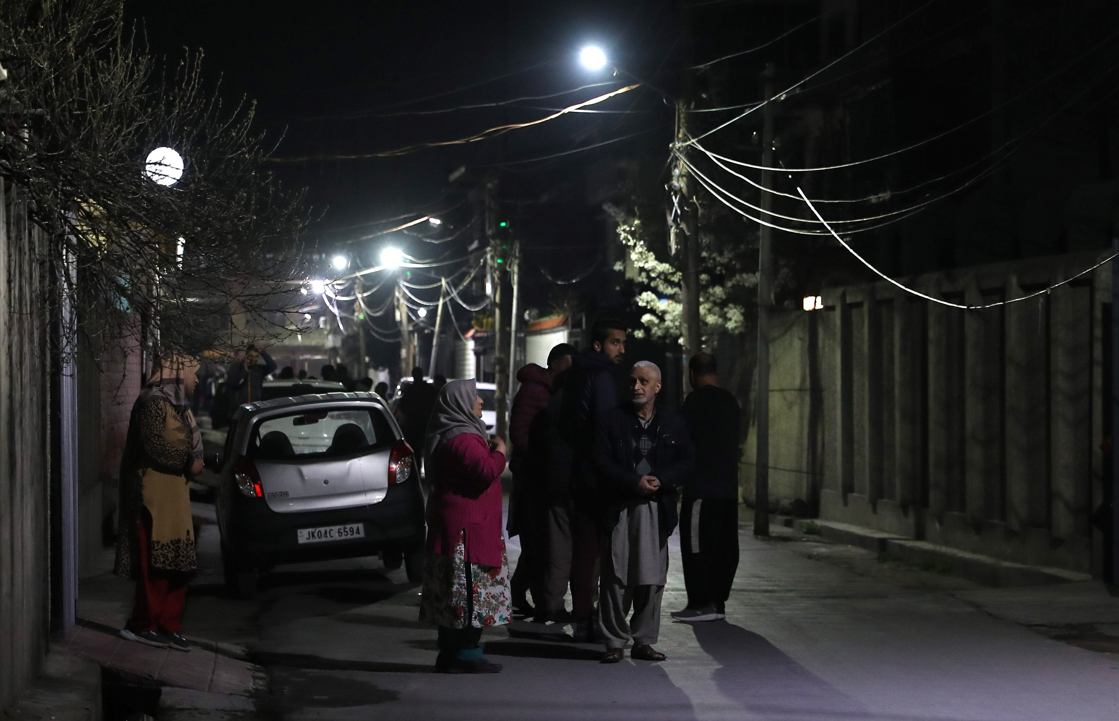 People on a road after tremors were felt in Srinagar, Indian-administered Kashmir