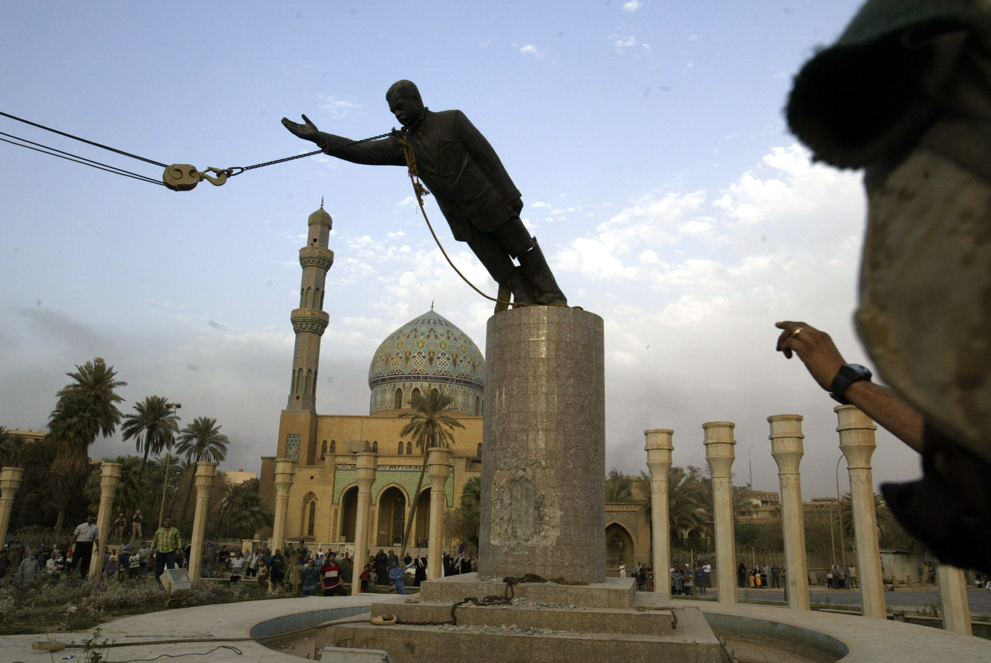 Saddam Hussein being toppled in downtown
