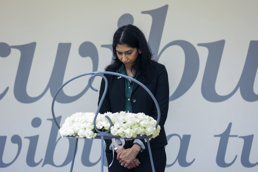Britain’s home secretary, Suella Braverman, stands by a wreath during a visit to the Kigali Genocide Memorial in the Rwandan capital [AP]