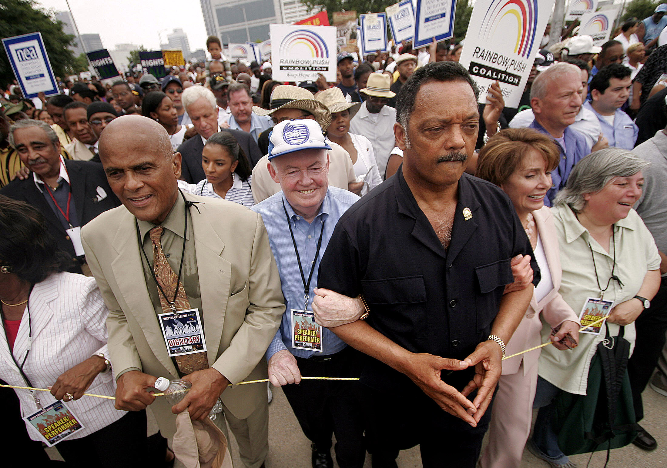 Civil rights activist Jesse Jackson, right-centre, leads a march with Belafonte, left, and others in downtown Atlanta to commemorate the 40th anniversary of the Voting Rights Act in 2005