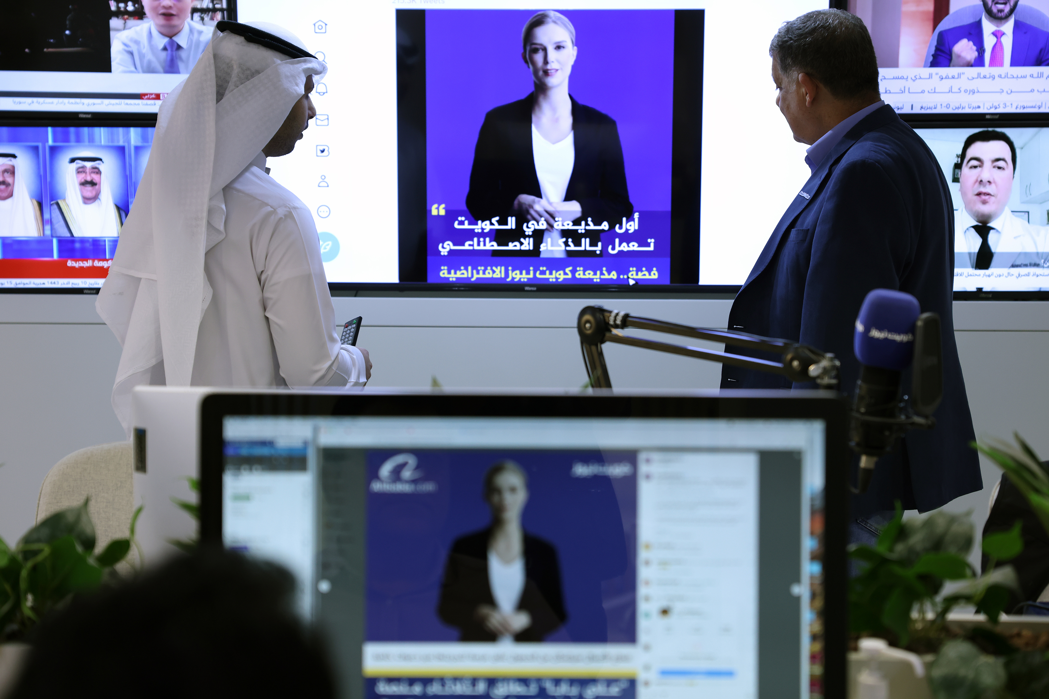Journalists watch an introductory video by Fedha on the Twitter account of Kuwait News service, in Kuwait City