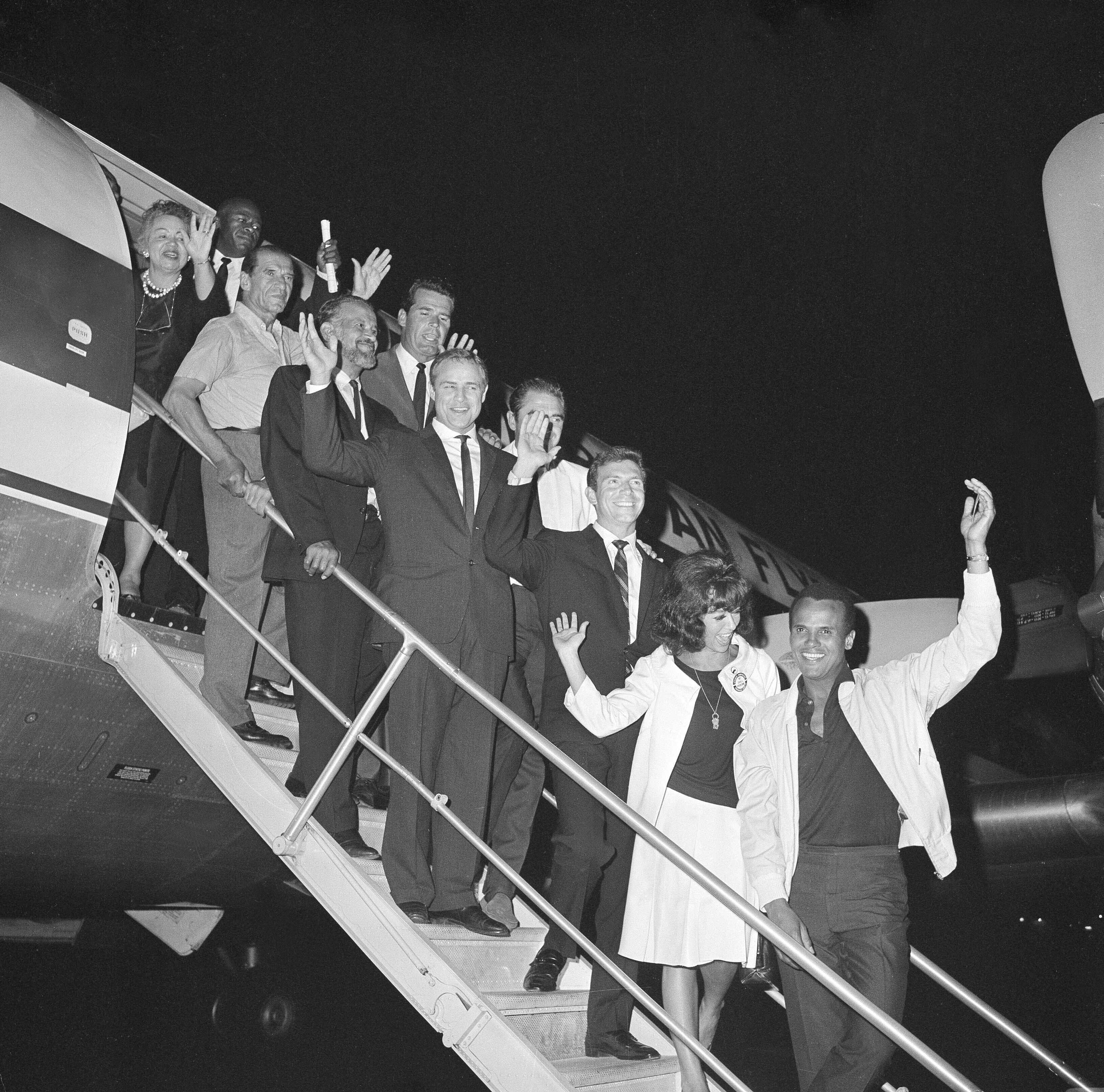 Hollywood celebrities, including Belafonte, pose on the steps before boarding an aeroplane for the March on Washington in 1963