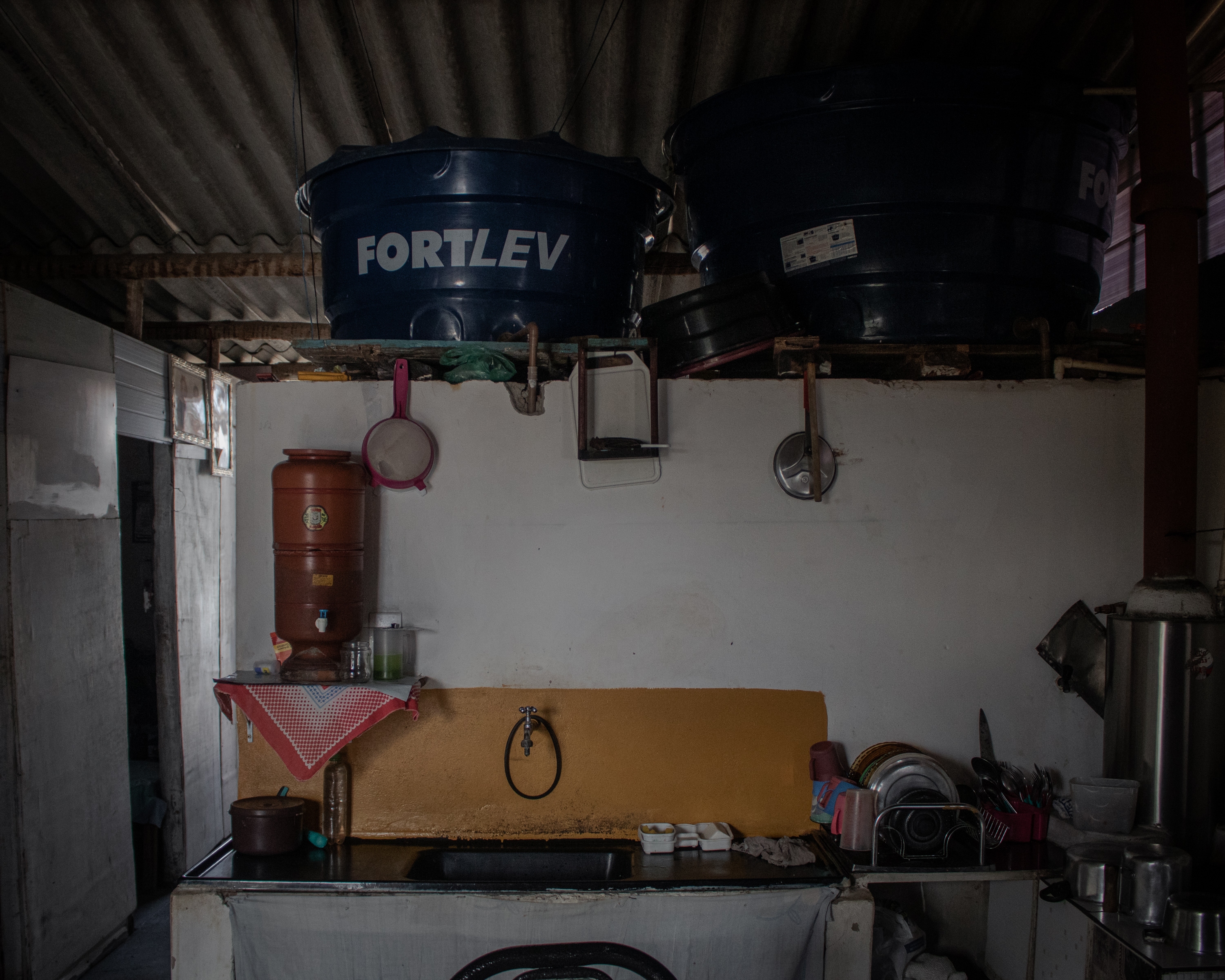 Mariele’s small kitchen is next to the bathroom, which has two water tanks above it
