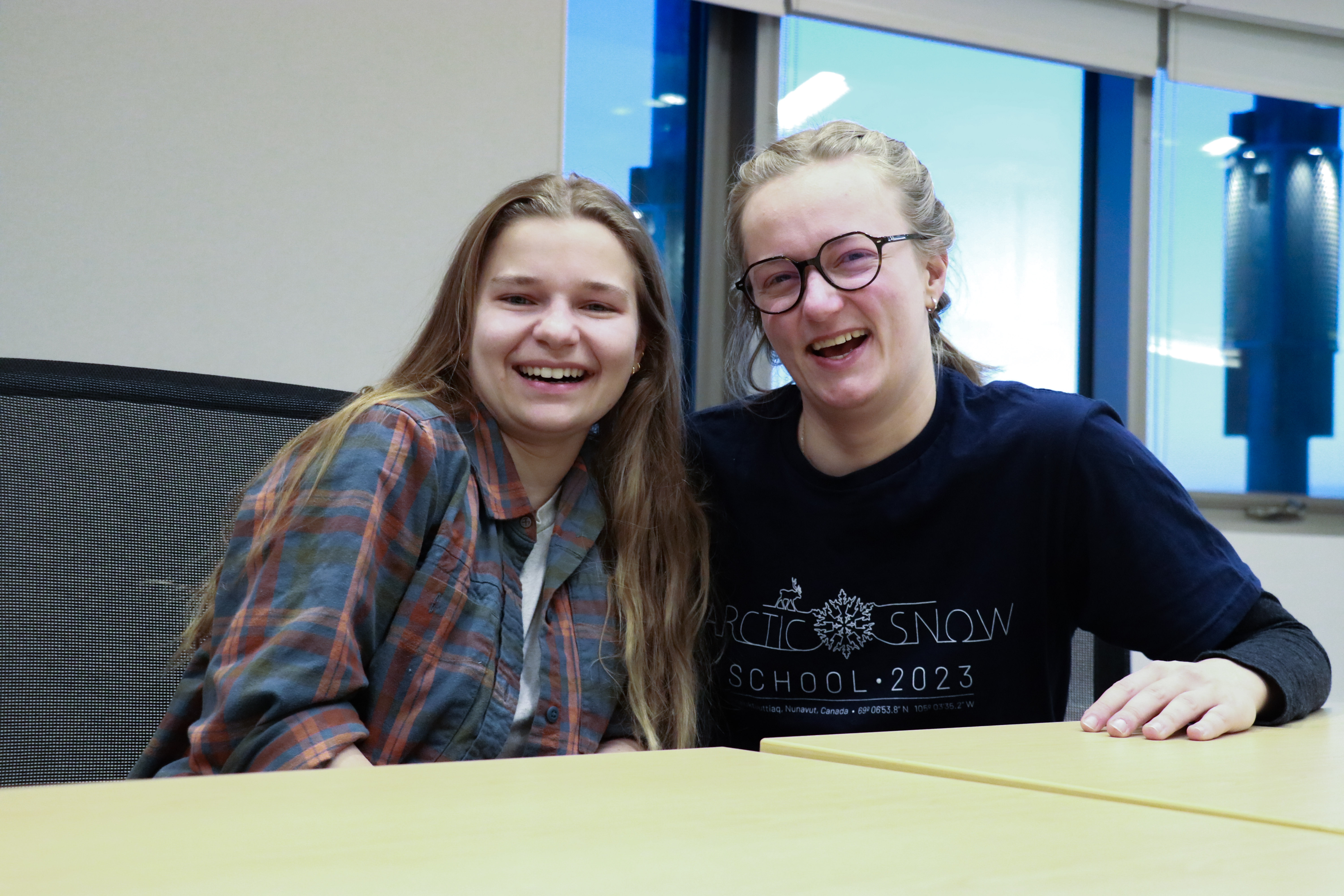 Two students laugh with each other at the Arctic Snow School