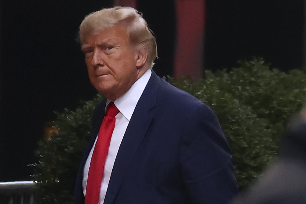 A close-up of Trump in a blue suit and red tie