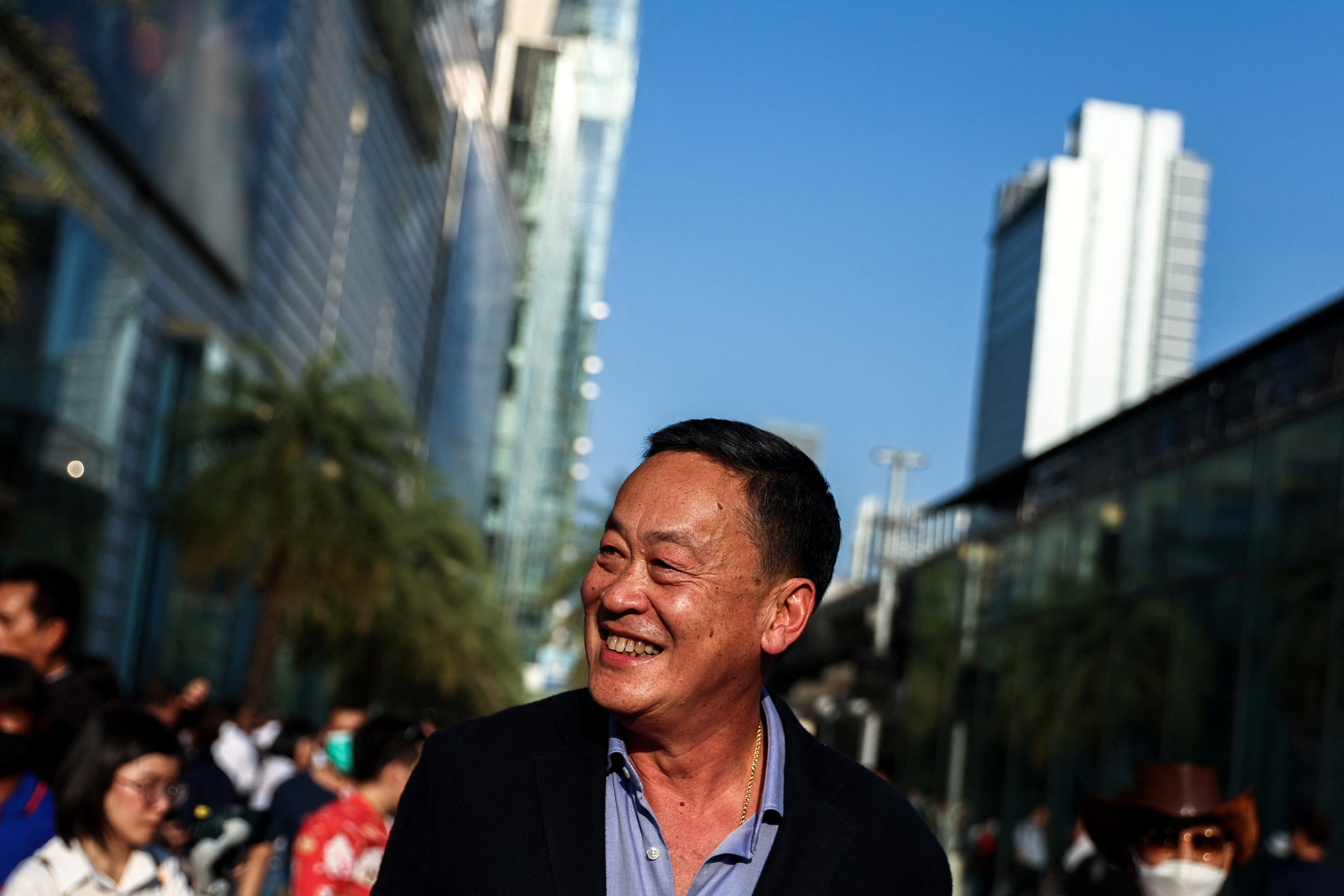 Srettha Thavisin smiling. He's on the streets of Bangkok.