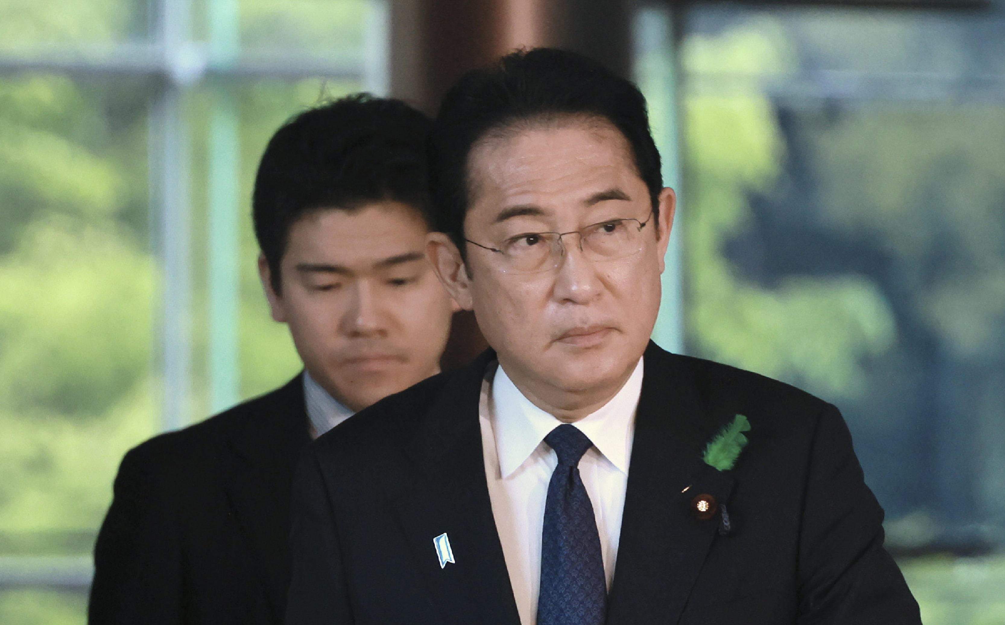 This photo taken on April 20, 2023 shows Japan's Prime Minister Fumio Kishida and his son Shotaro Kishida arriving at the prime minister's office