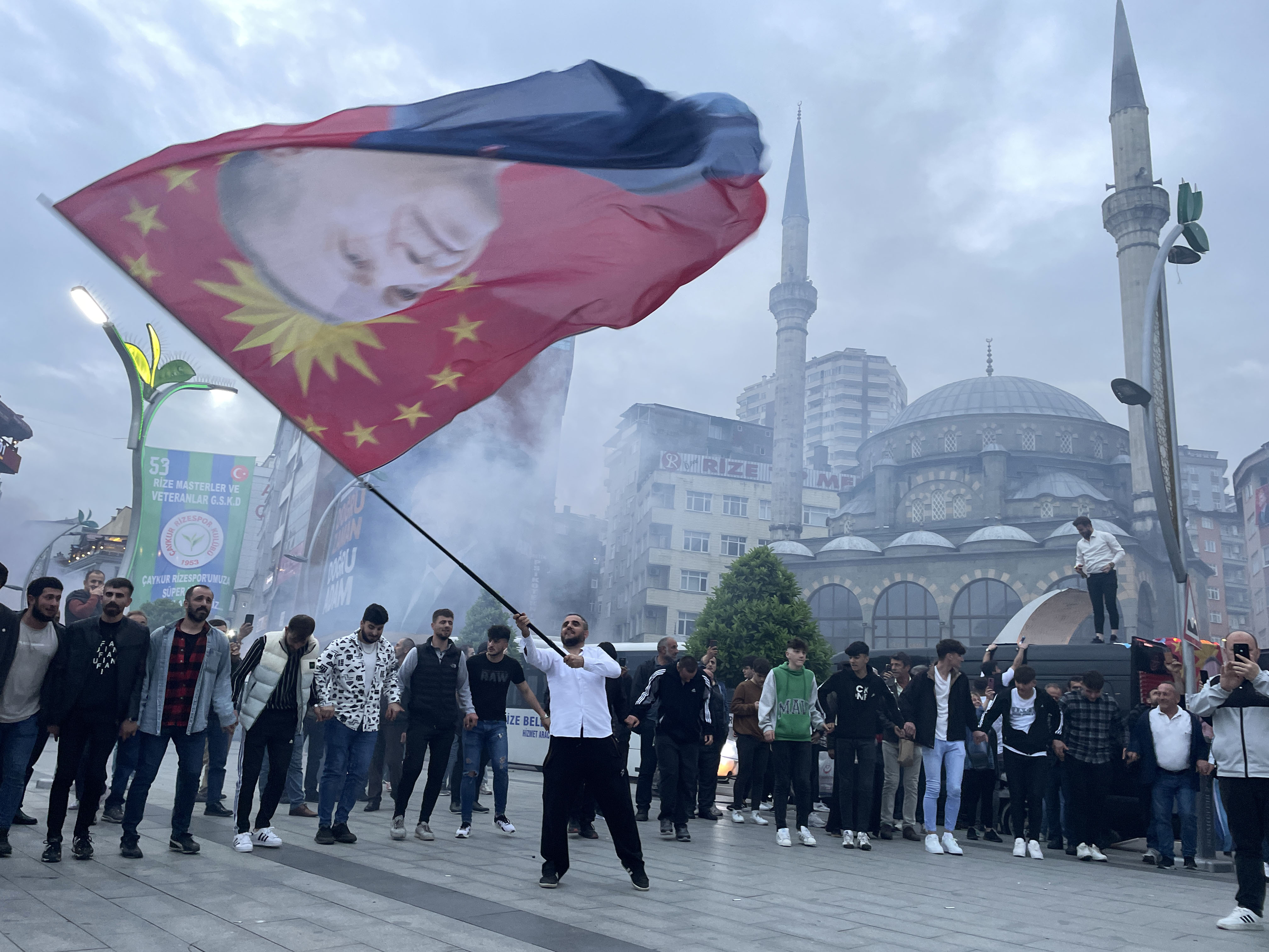 Citizens supporting Justice and Development (AK) Party celebrate after voting in the country's presidential runoff