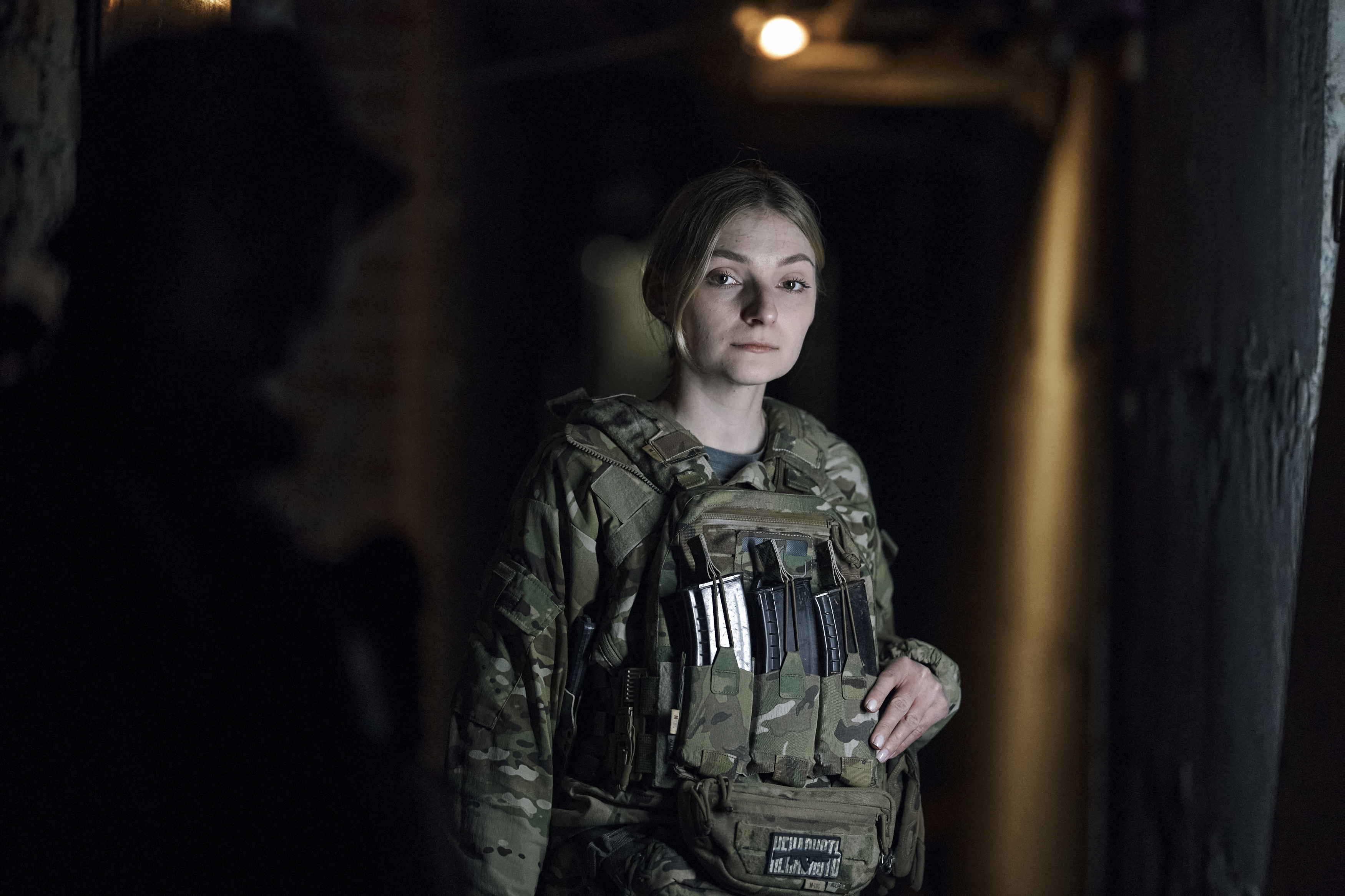 A Ukrainian female soldier poses for a portrait at a shelter near Bakhmut, an eastern city where fierce battles against Russian forces have been taking place, in the Donetsk region, Ukraine, Saturday, April 29, 2023.