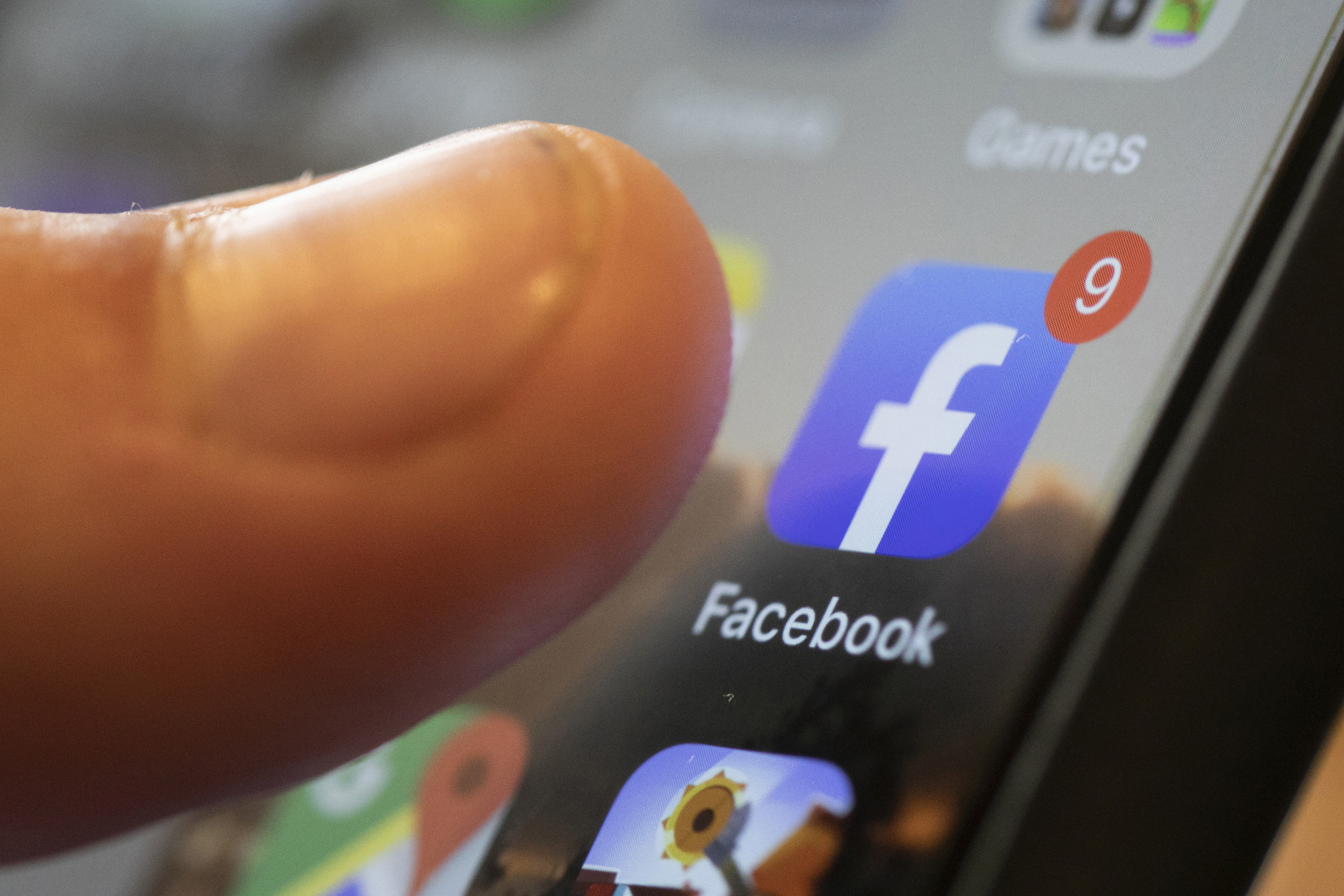 A phone displays the Facebook app in New Orleans