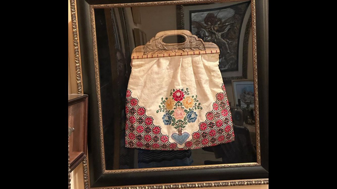 Giries has the bag her mother carried when they fled their home framed, a reminder of the hardship of exile and resilience of her family [Courtesy of Leila Giries]