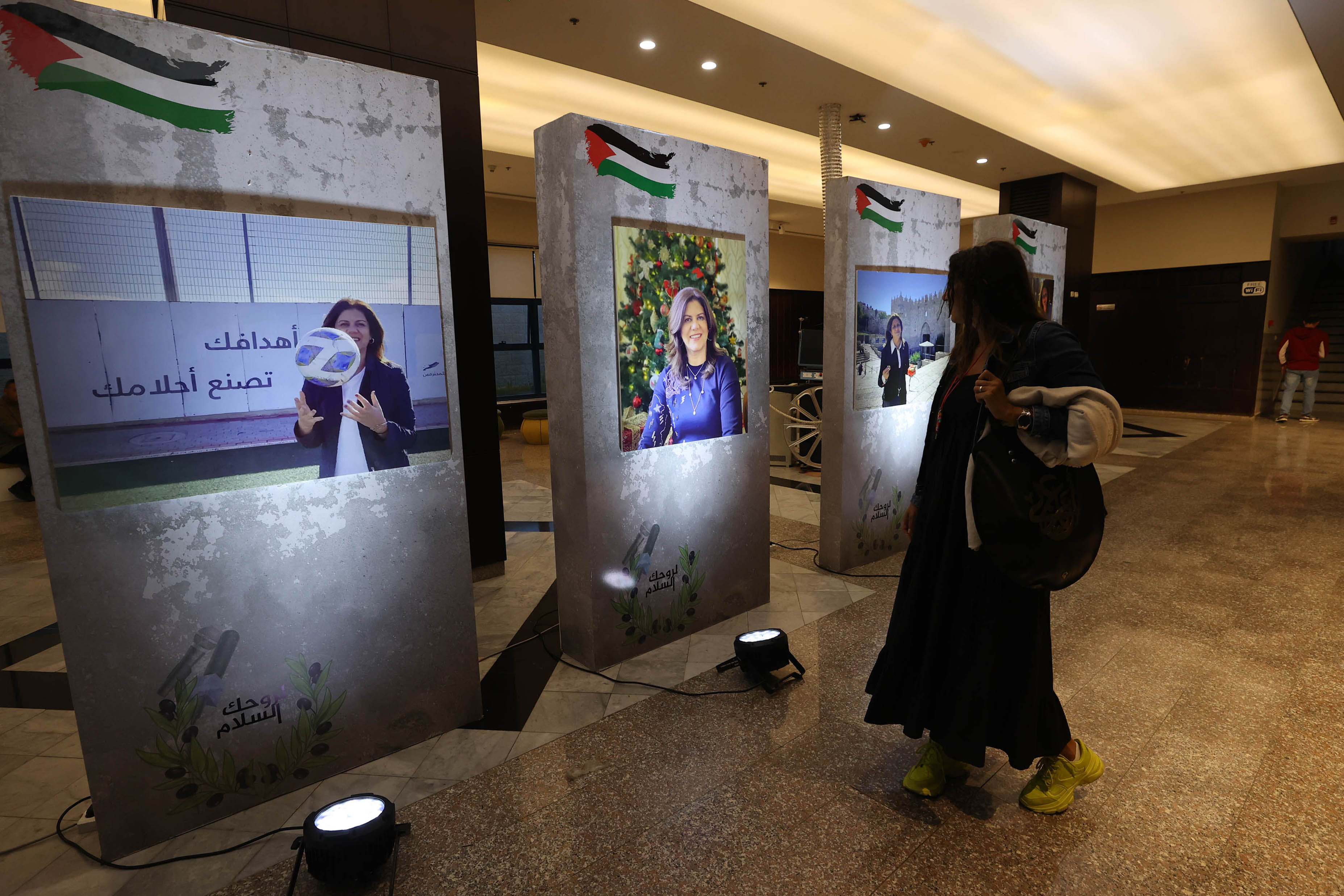 Photos of Shireen were placed at the entrance to the auditorium of the Ramallah Cultural Palace [Al Jazeera]