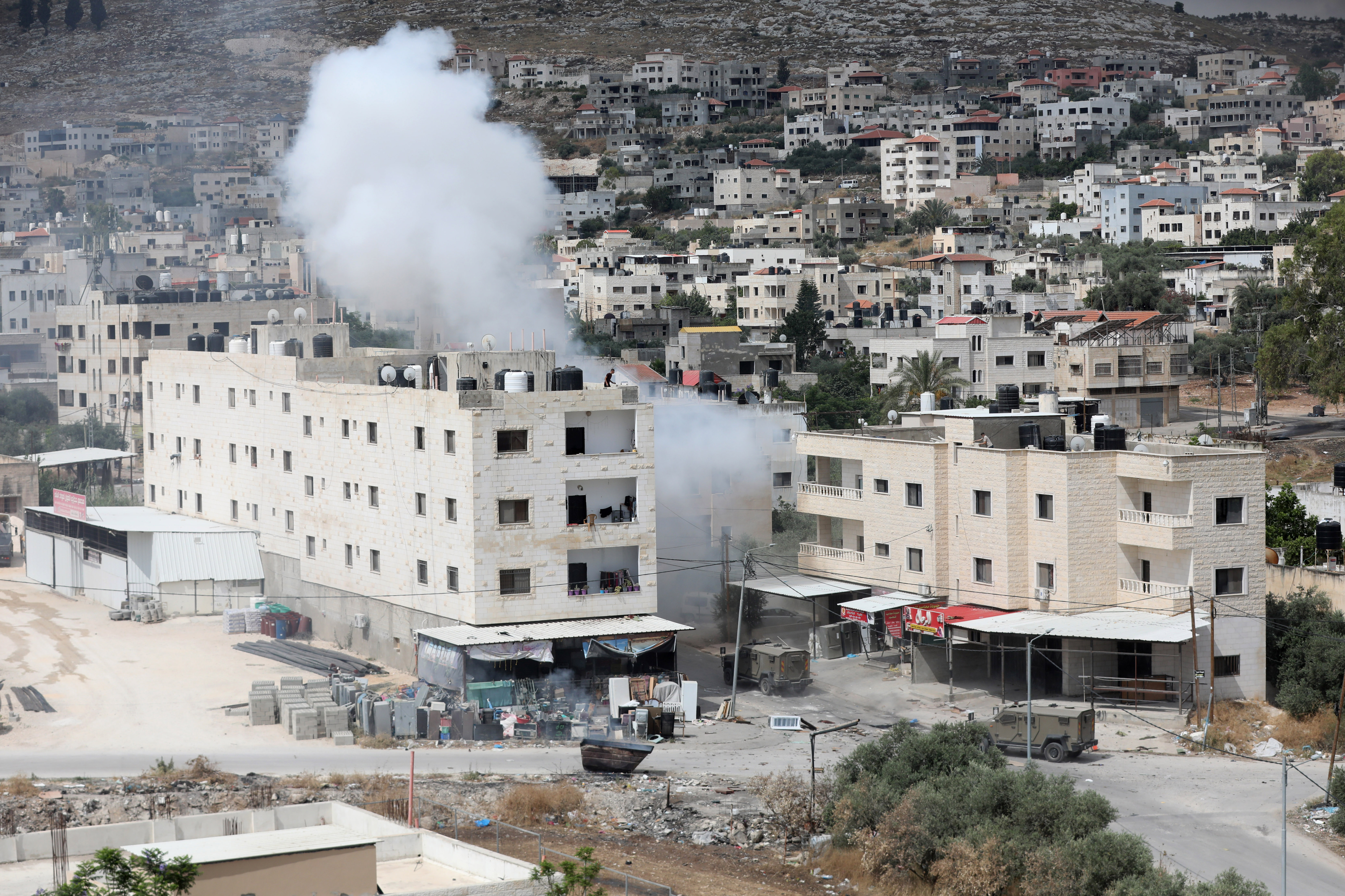 Smoke billows from an explosion during an Israeli army raid