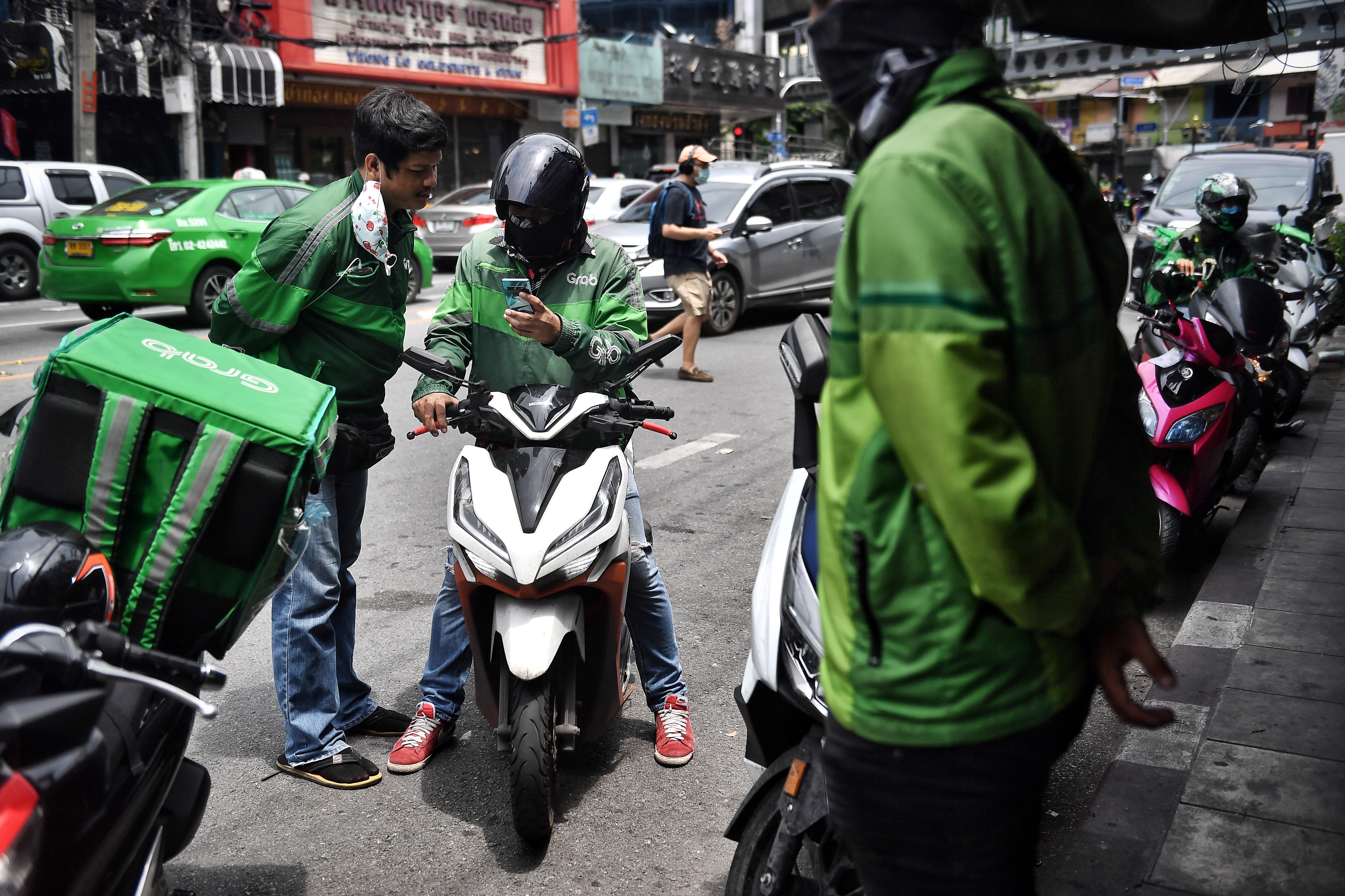 Grab delivery drivers in Bangkok waiting for orders