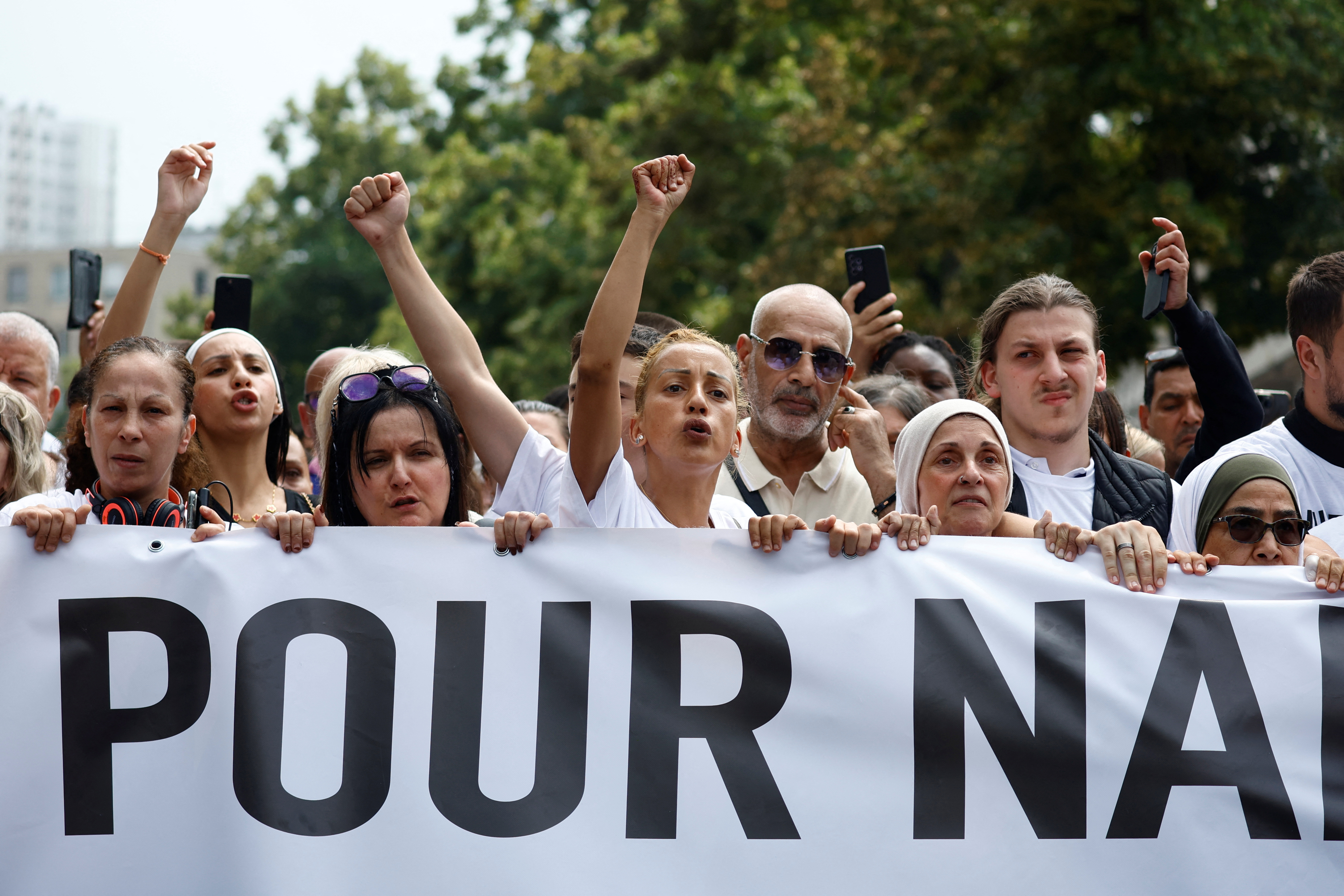 People attend a march in tribute to Nahel
