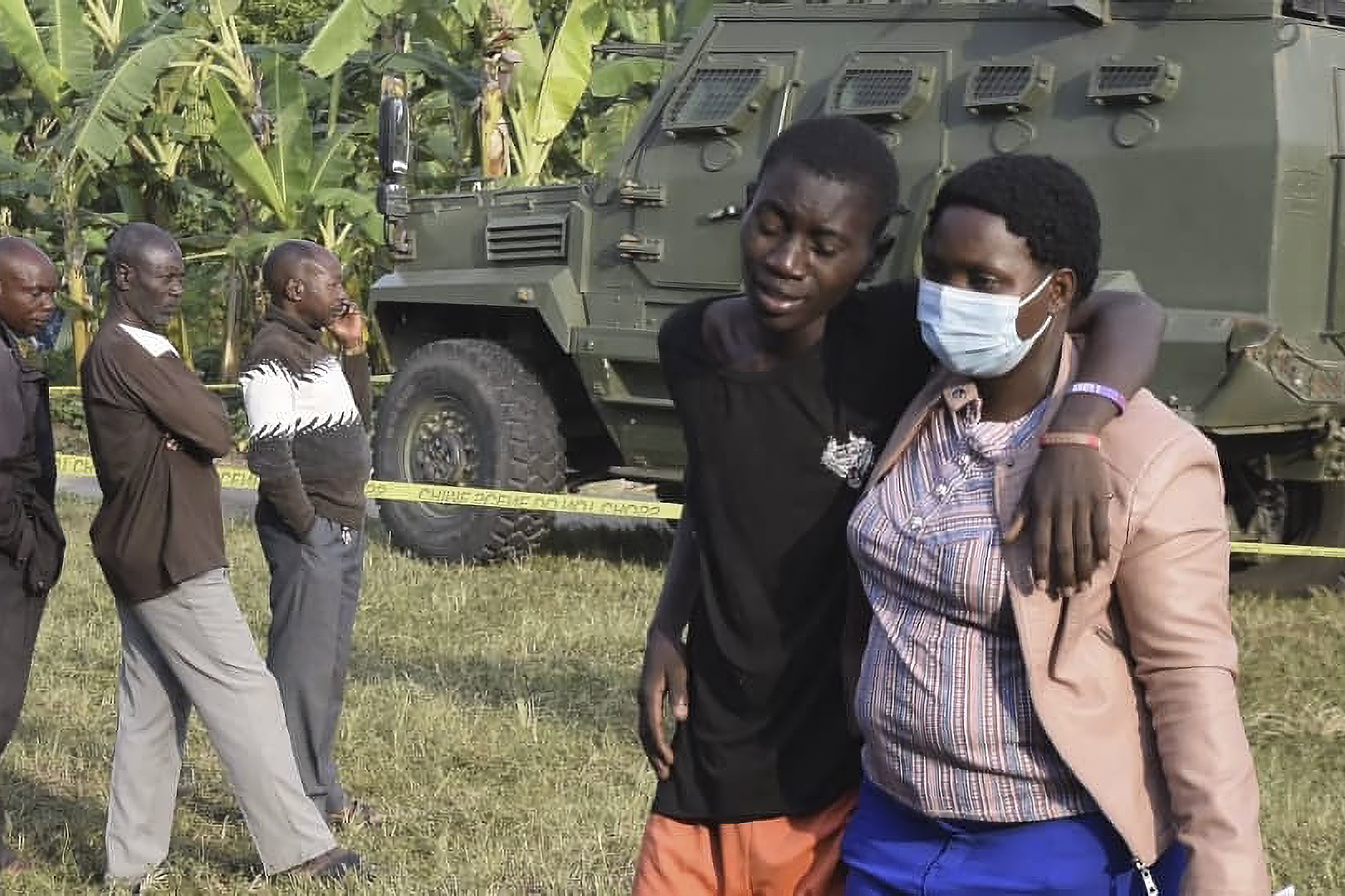 A boy is conforted at the scene of an attack in Mpondwe