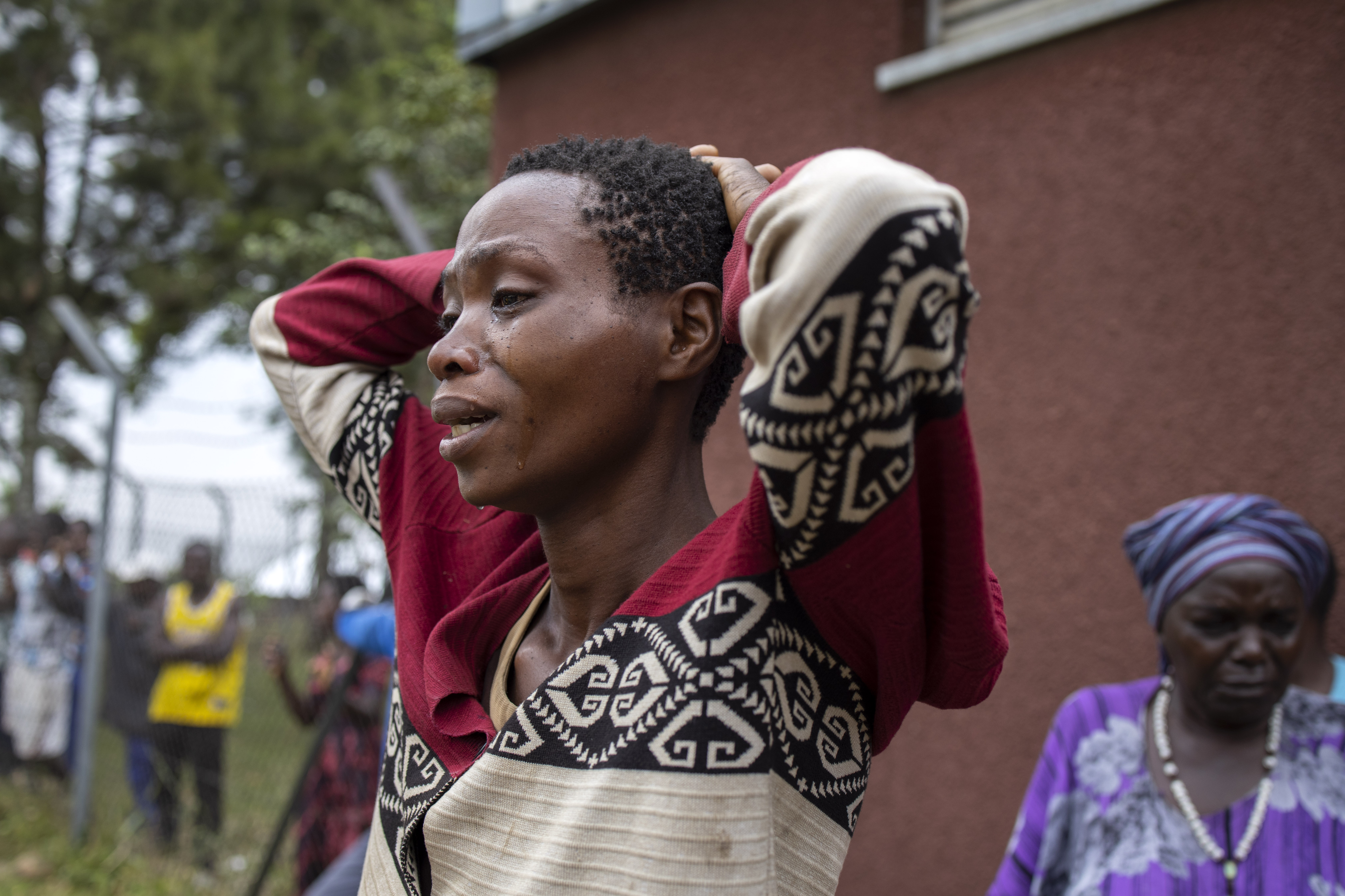 The relative of a victim of the Mpondwe Lhubiriha Secondary School mourns outside the Bwera General Hospital Mortuary, Kasese,