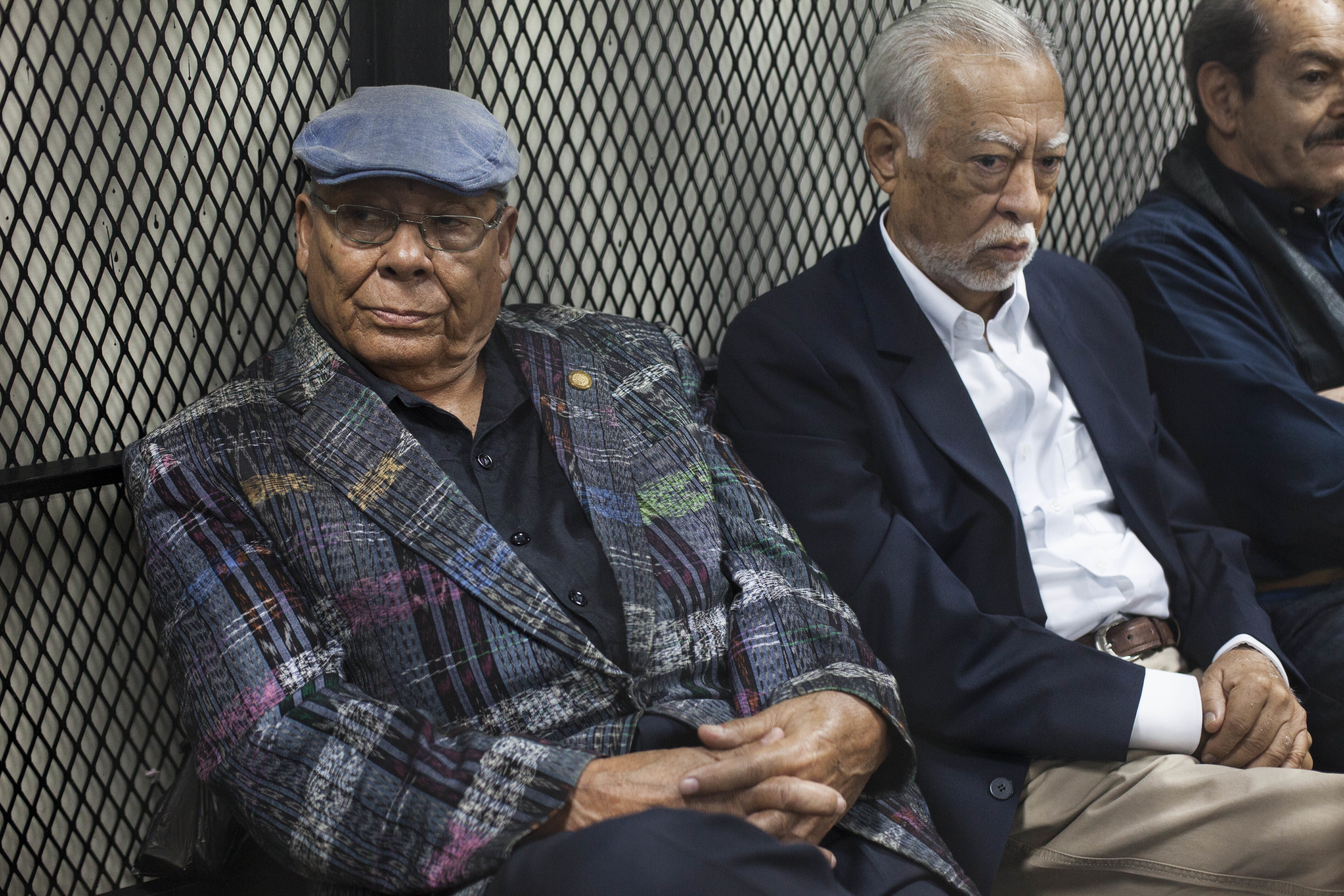 FILE - Former army officers Benedicto Lucas Garcia, left, and Edilberto Letona Linares, sit in a cell at a courtroom in Guatemala City, Thursday, March 2, 2017