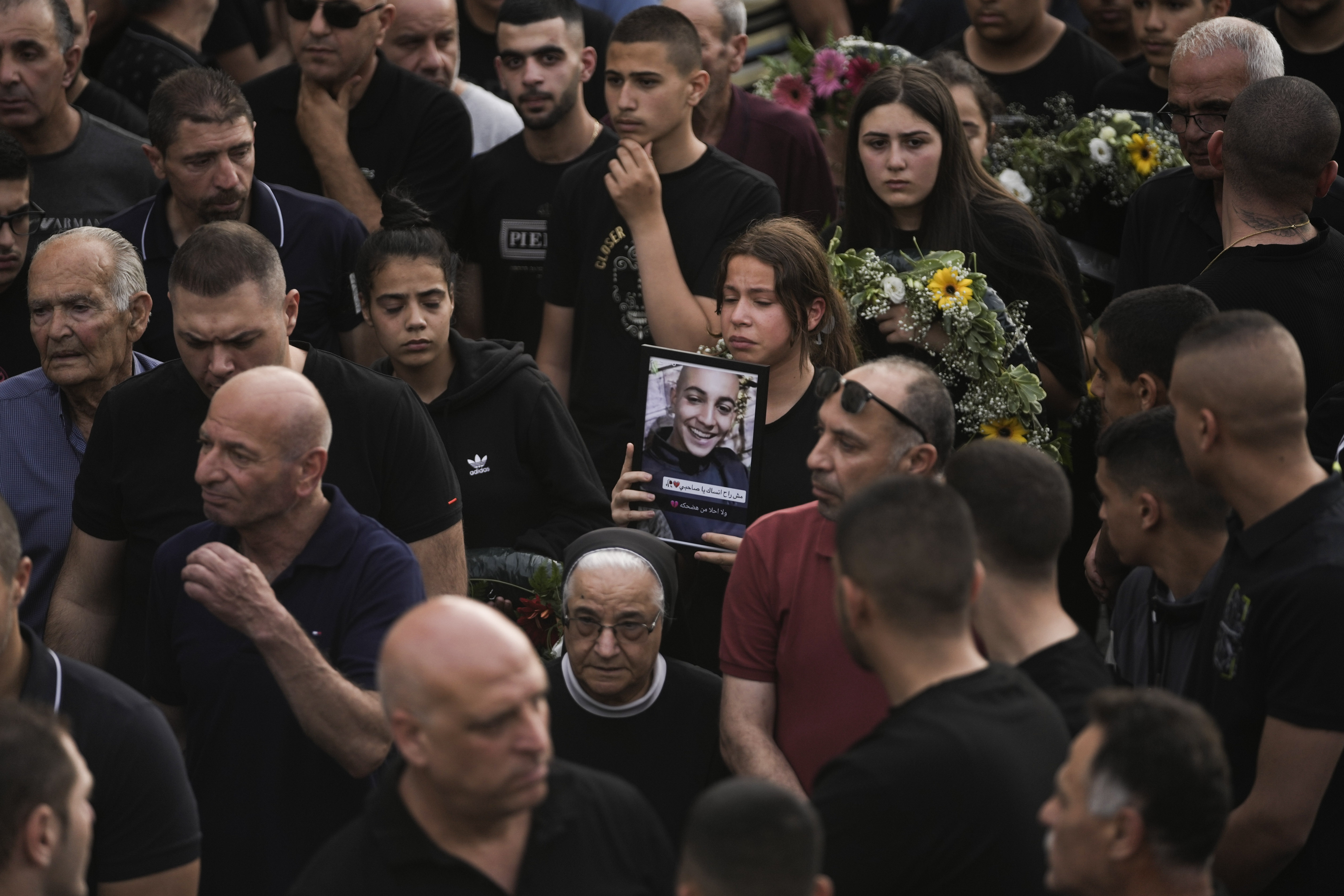 Mourners carry the coffins of two of five Palestinian citizens of Israel who were killed when a gunman opened fire at a car wash in Yafa an-Naseriyye, near Nazareth, Israel, June 8, 2023