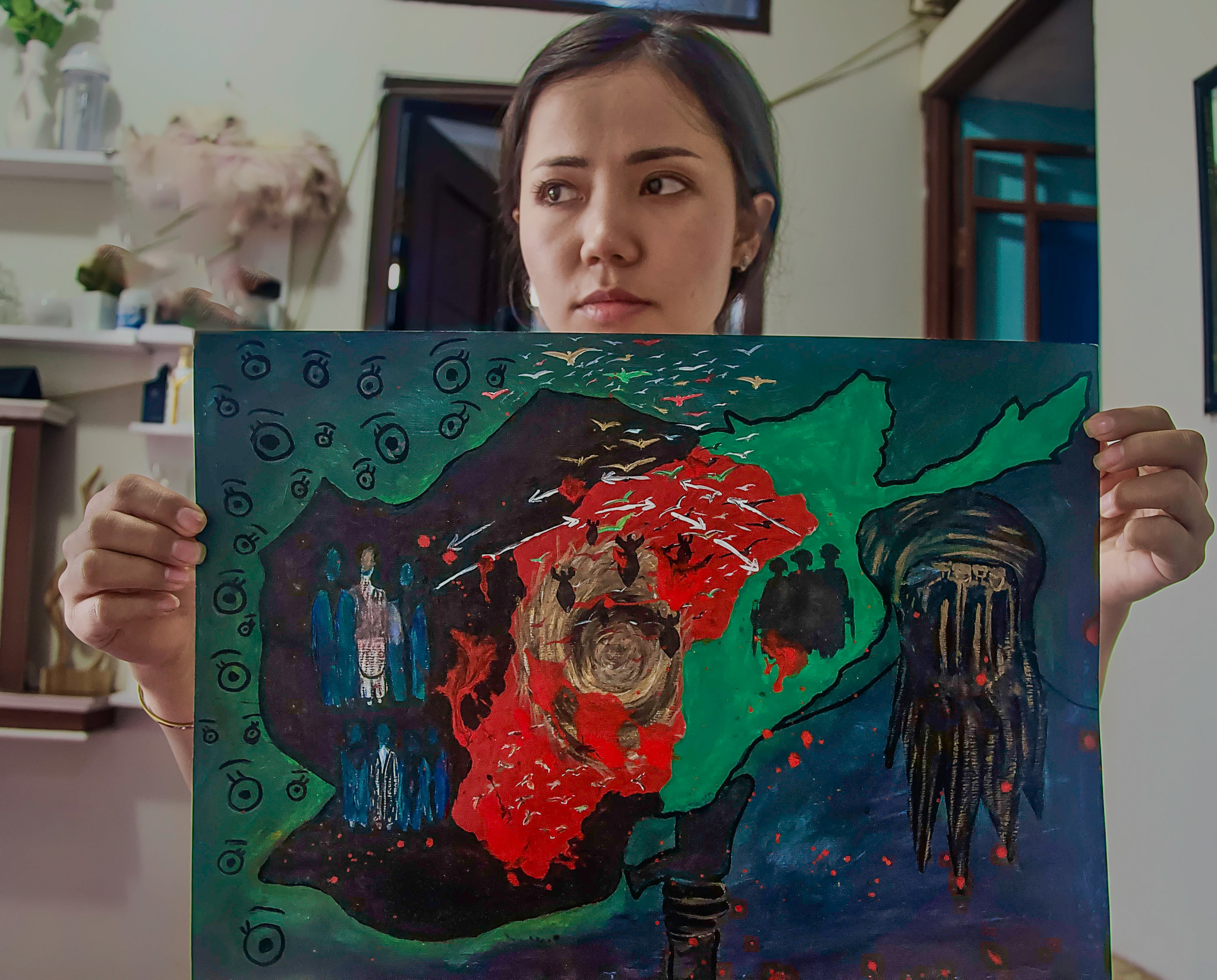 Farahanz Salehi holds her painting, August 15, depicting the fall of Kabul