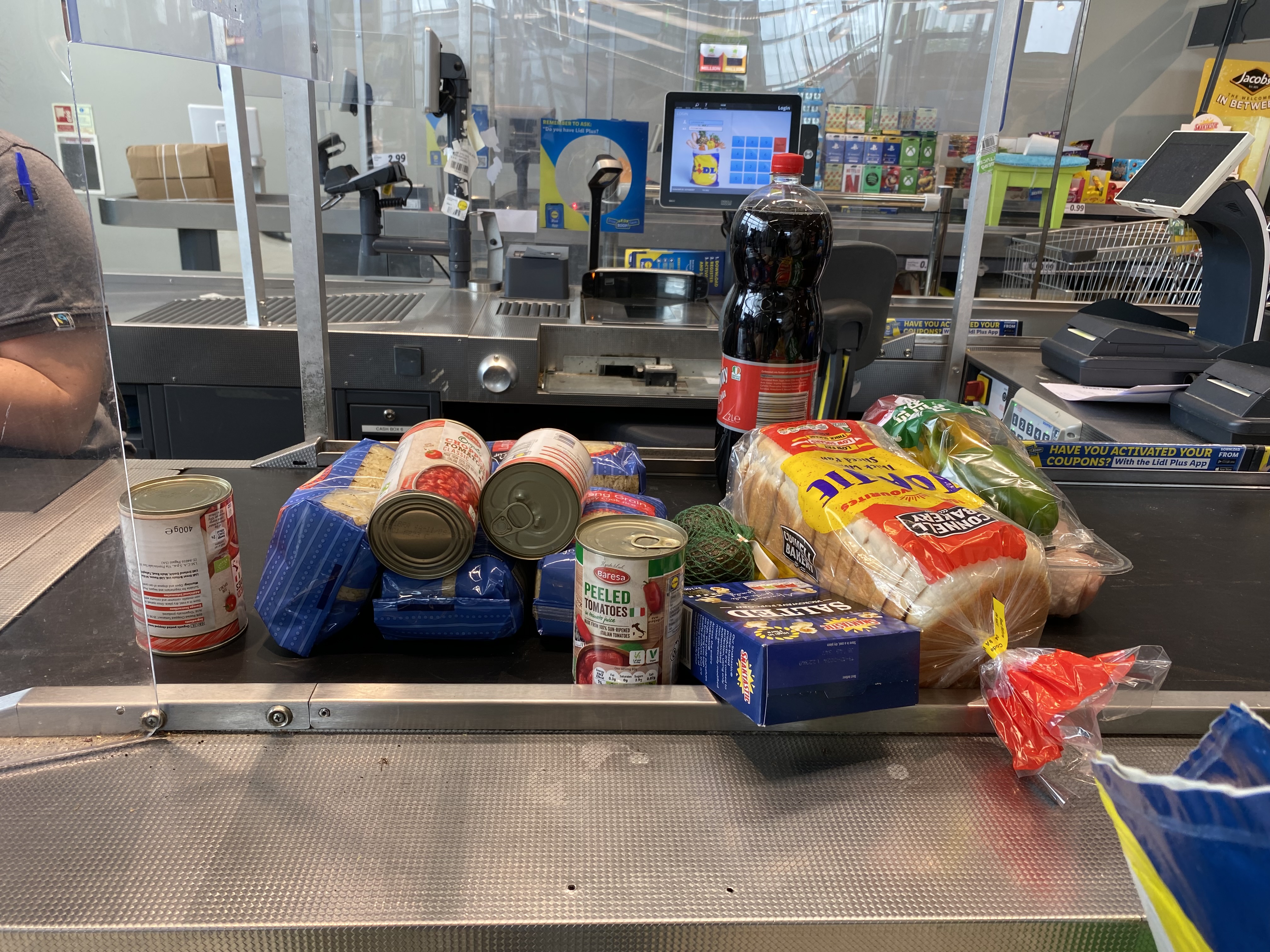 Fatama rings up her purchases at a till point at the supermarket