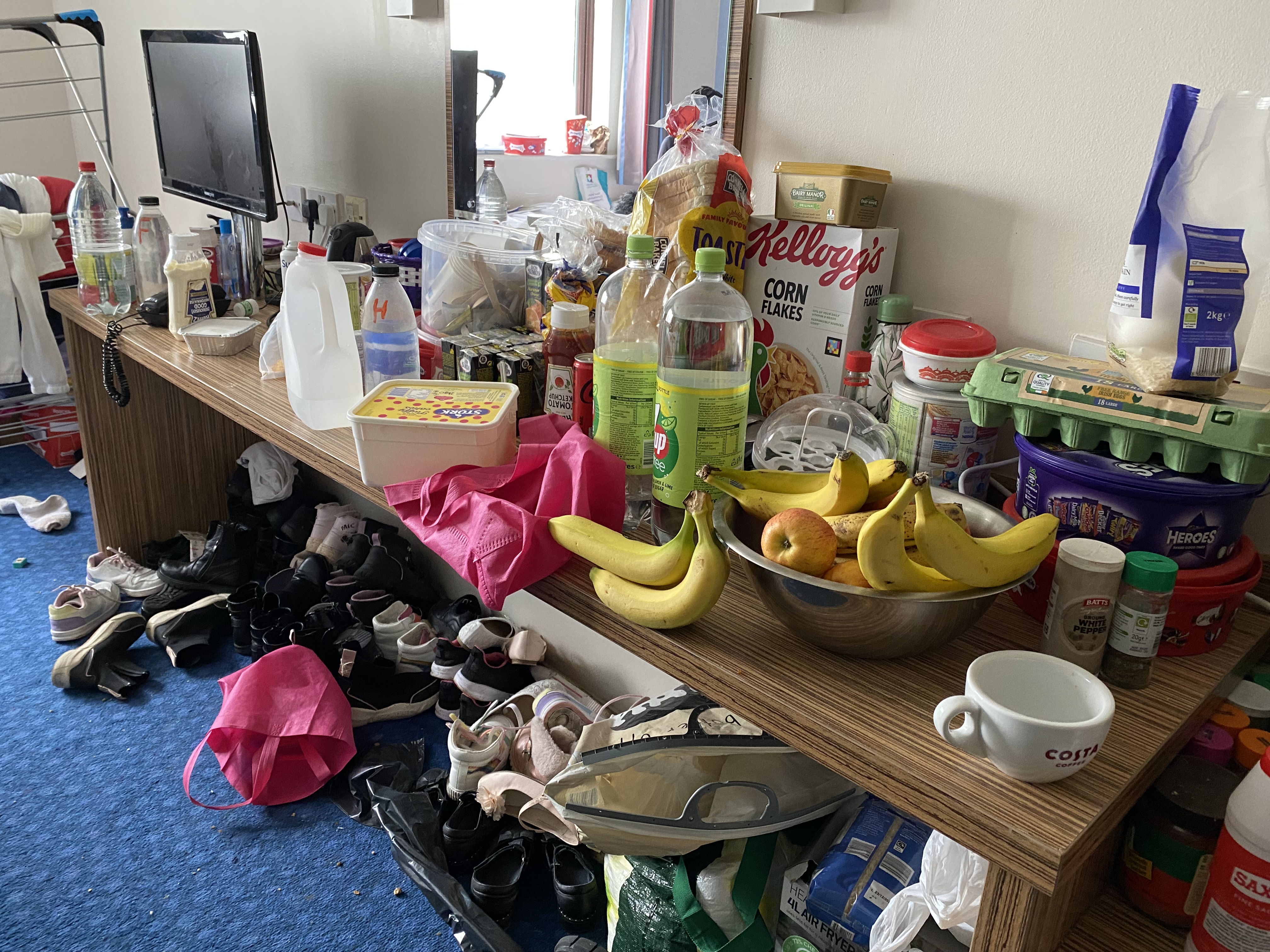 Fatma and her daughters live in a small hostel room, where there is just one table and two beds
