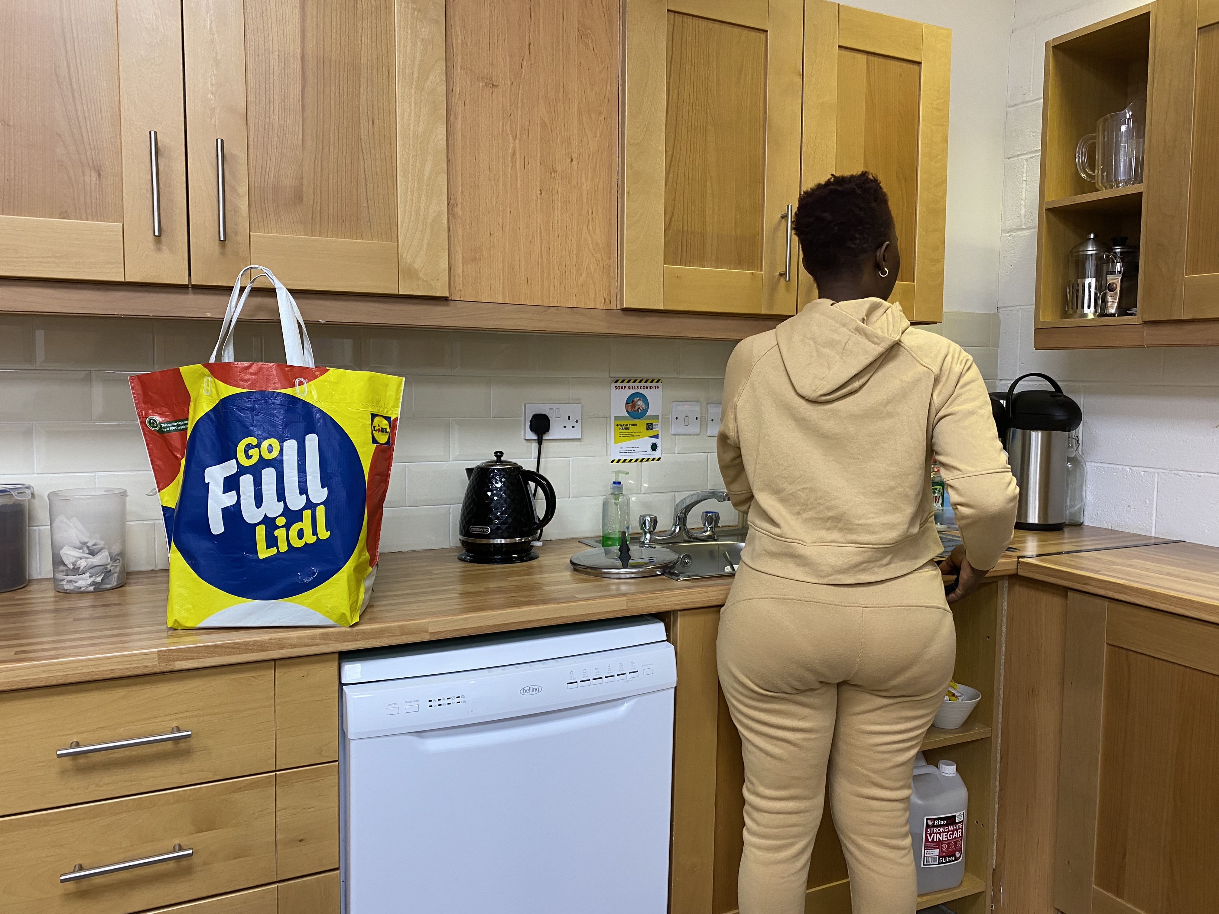 Fatama prepares to cook food in the kitchen of a local NGO