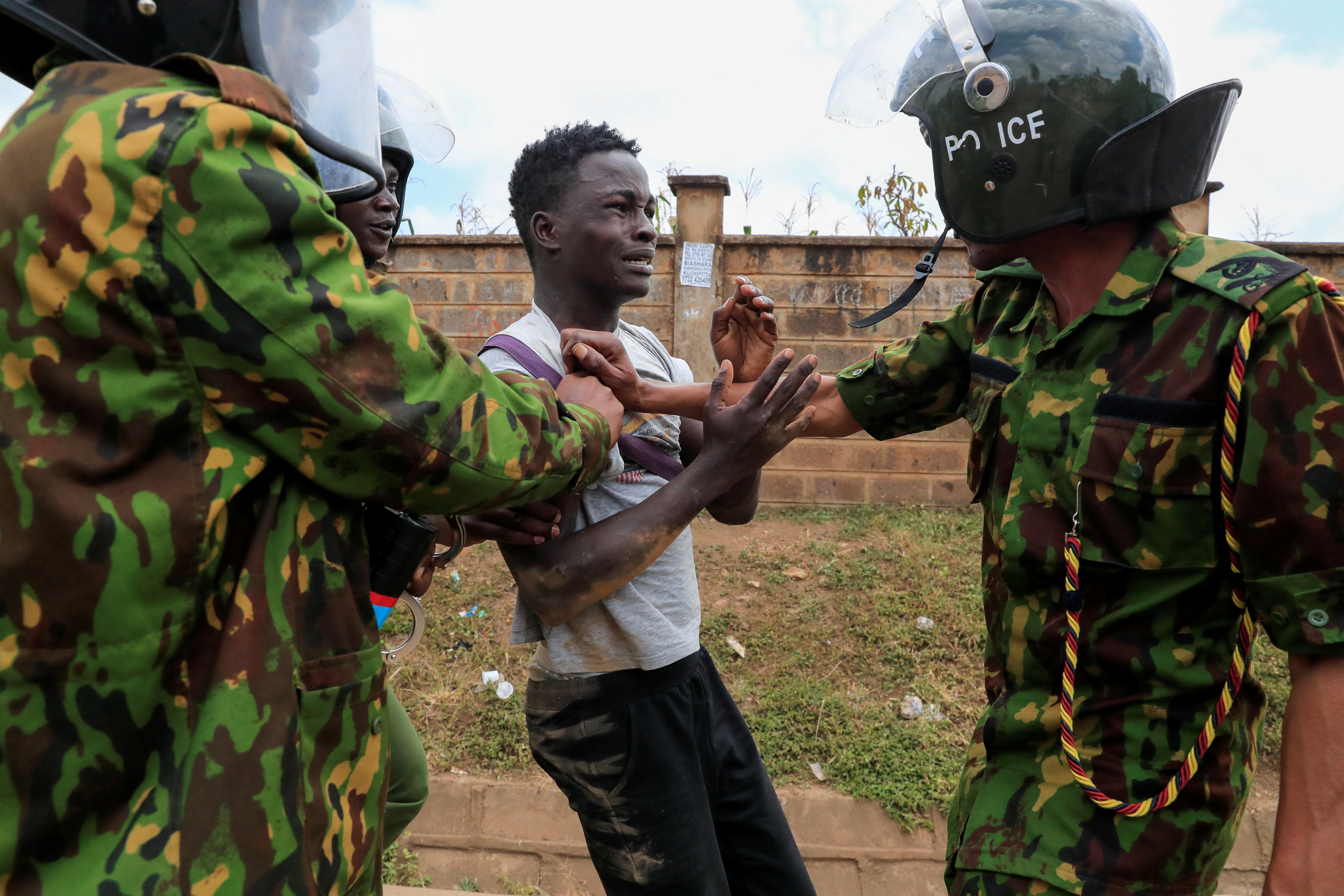 Riot police detain a supporte