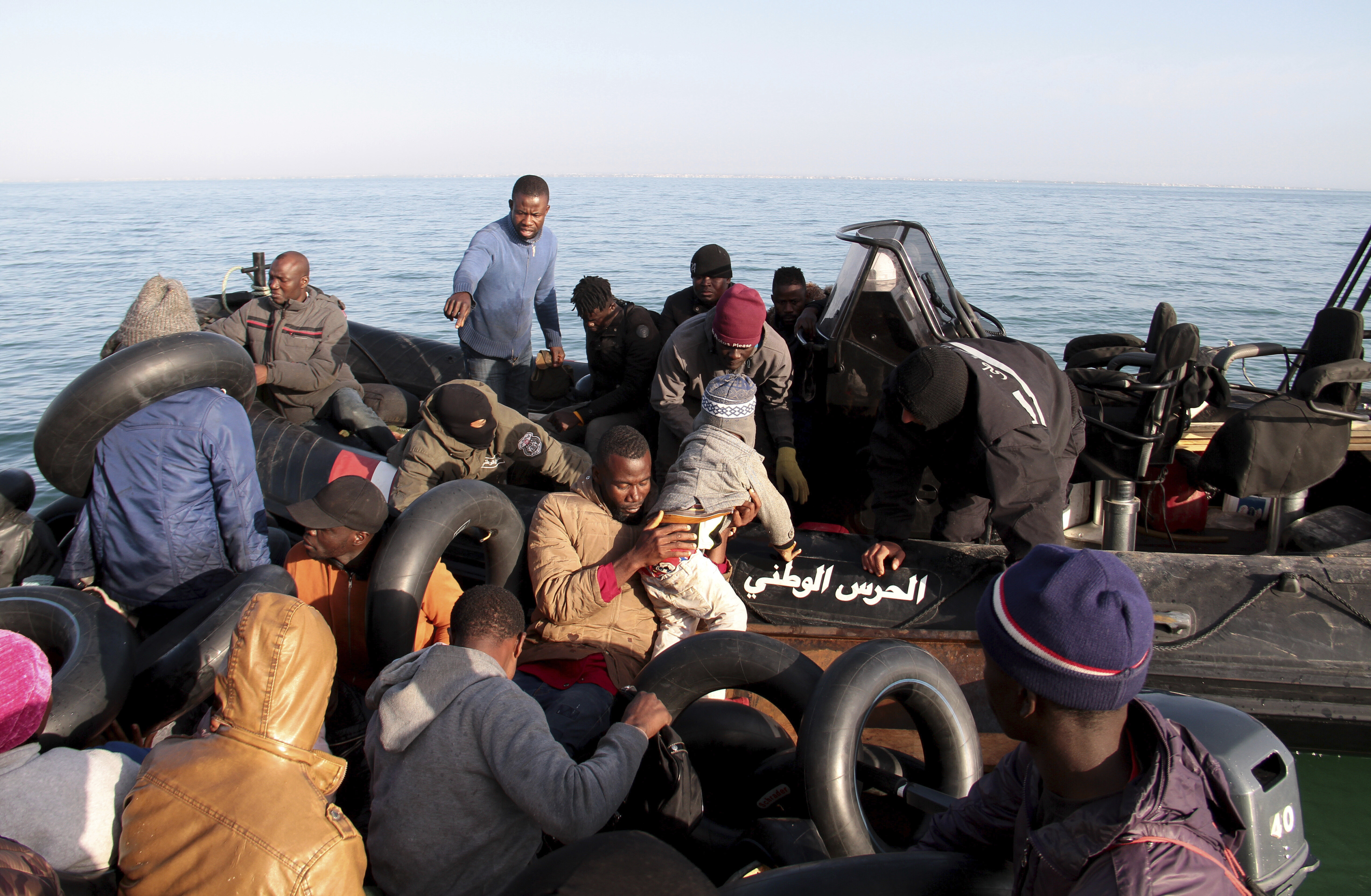 Migrants, mainly from sub-Saharan Africa, are stopped by Tunisian Maritime National Guard at sea during an attempt to get to Italy, near the coast of Sfax, Tunisia, Tuesday, April 18, 2023.