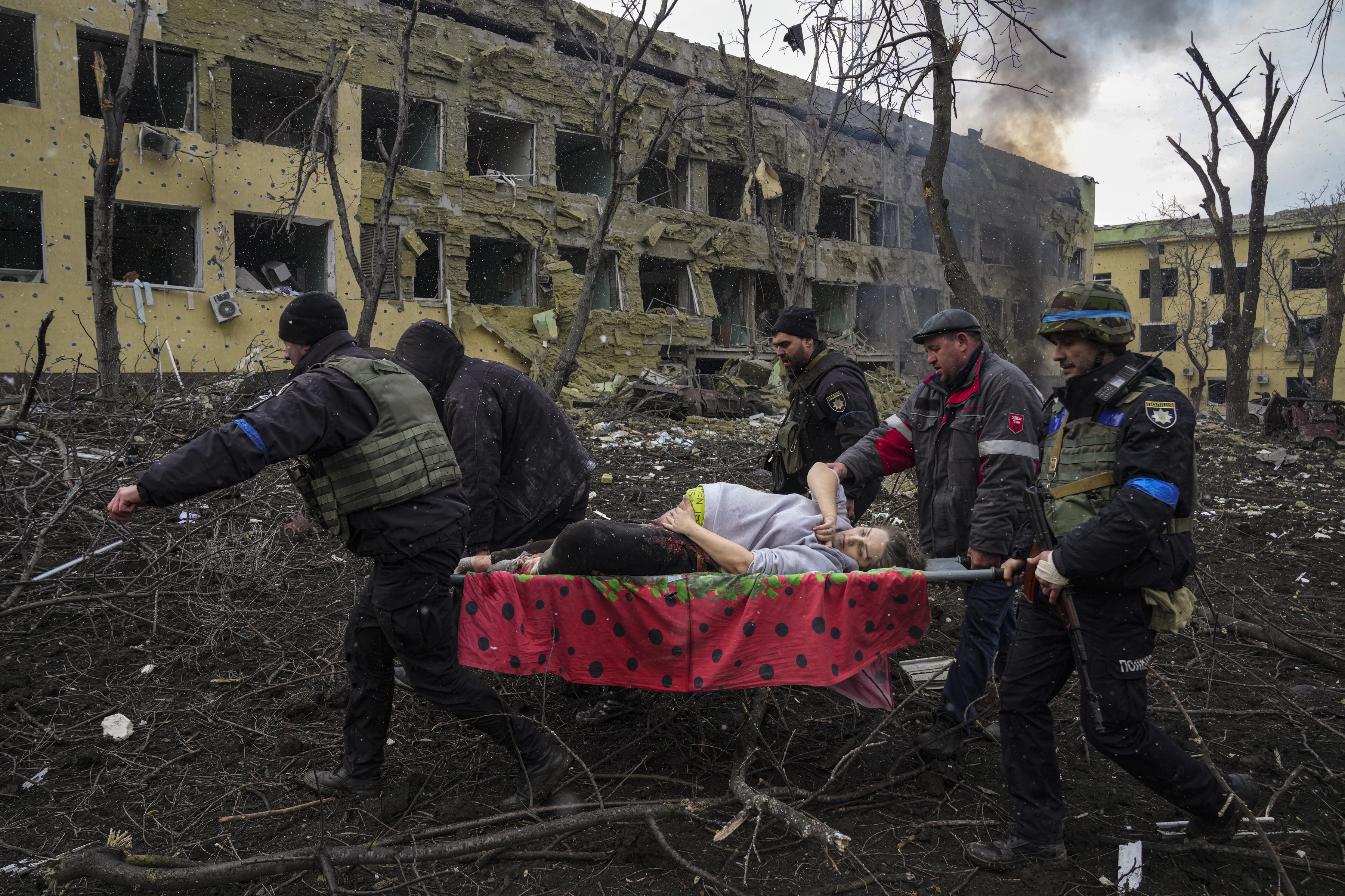 Ukrainian emergency employees and police officers evacuate injured pregnant woman Iryna Kalinina, 32, from a maternity hospital that was damaged by a Russian airstrike in Mariupol,