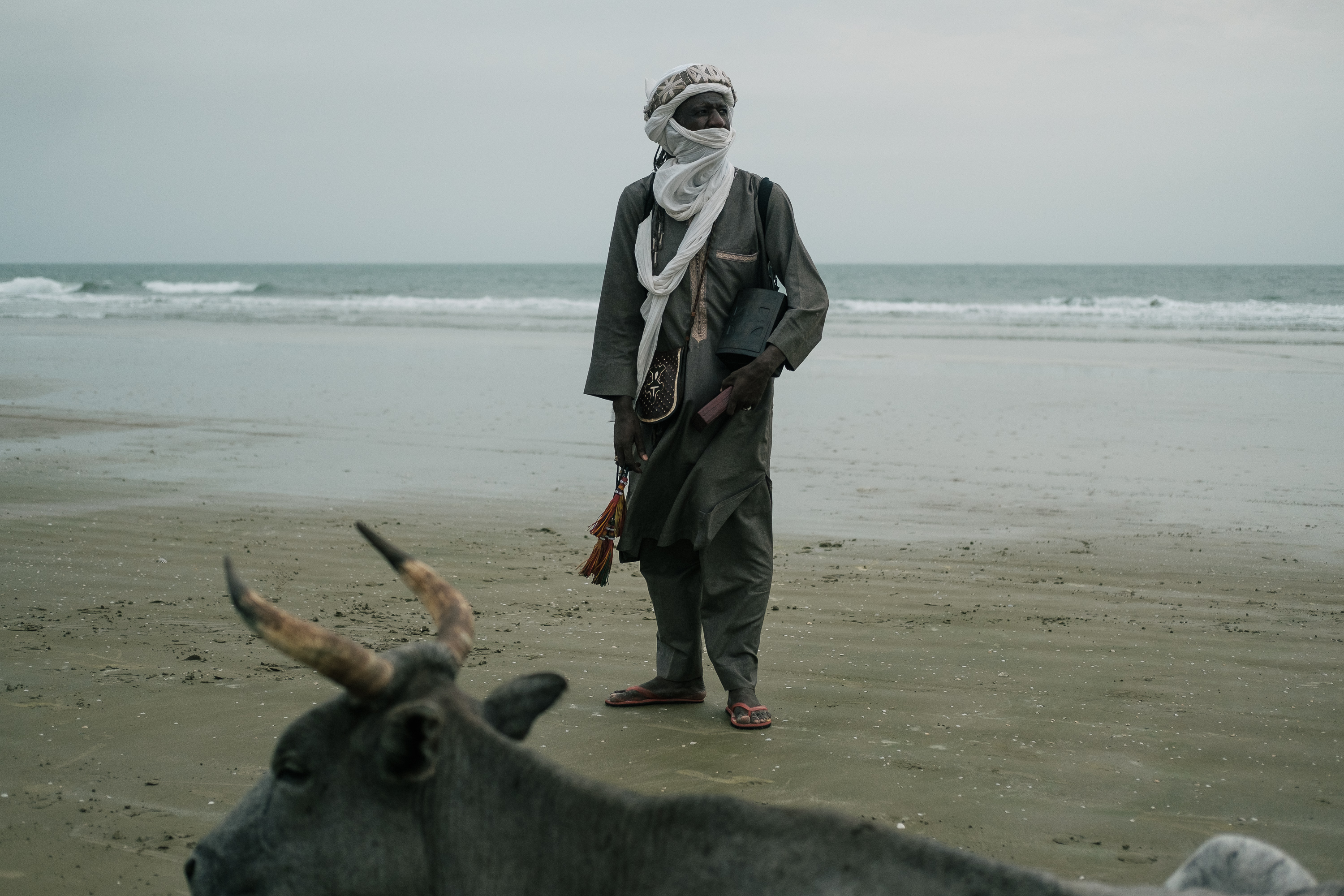 Almounzer Dicko stands on the long beach outside Cap Skirring in Casamance