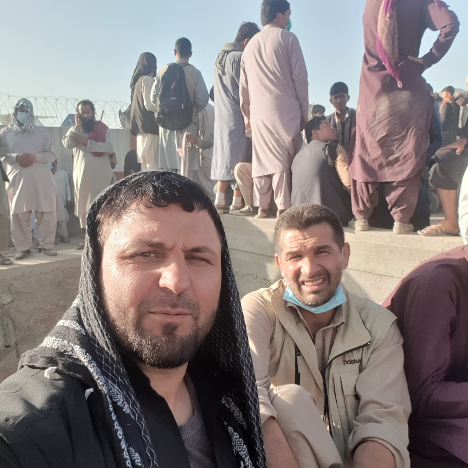 Hazrati, right, attempted to get into Kabul airport in August 2021 after the Taliban took control [Courtesy of Farhad Hazrati]