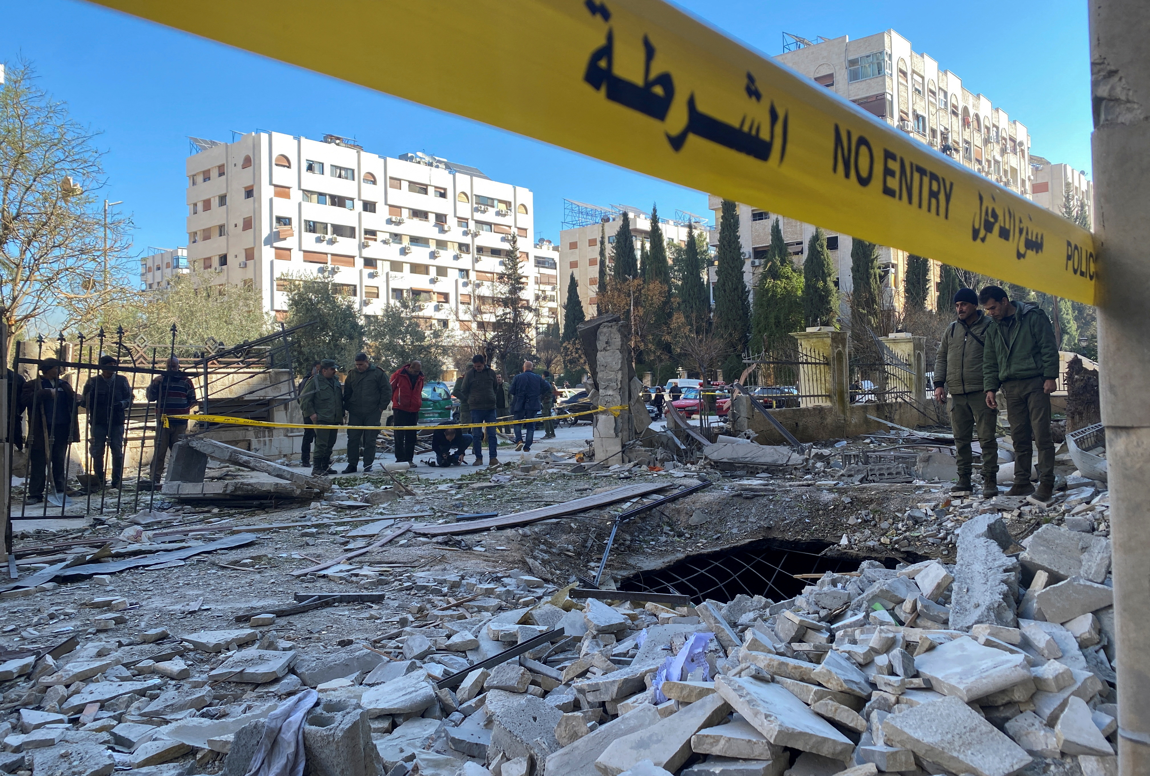 Yellow caution tape outlines an area of debris from a missile attack.