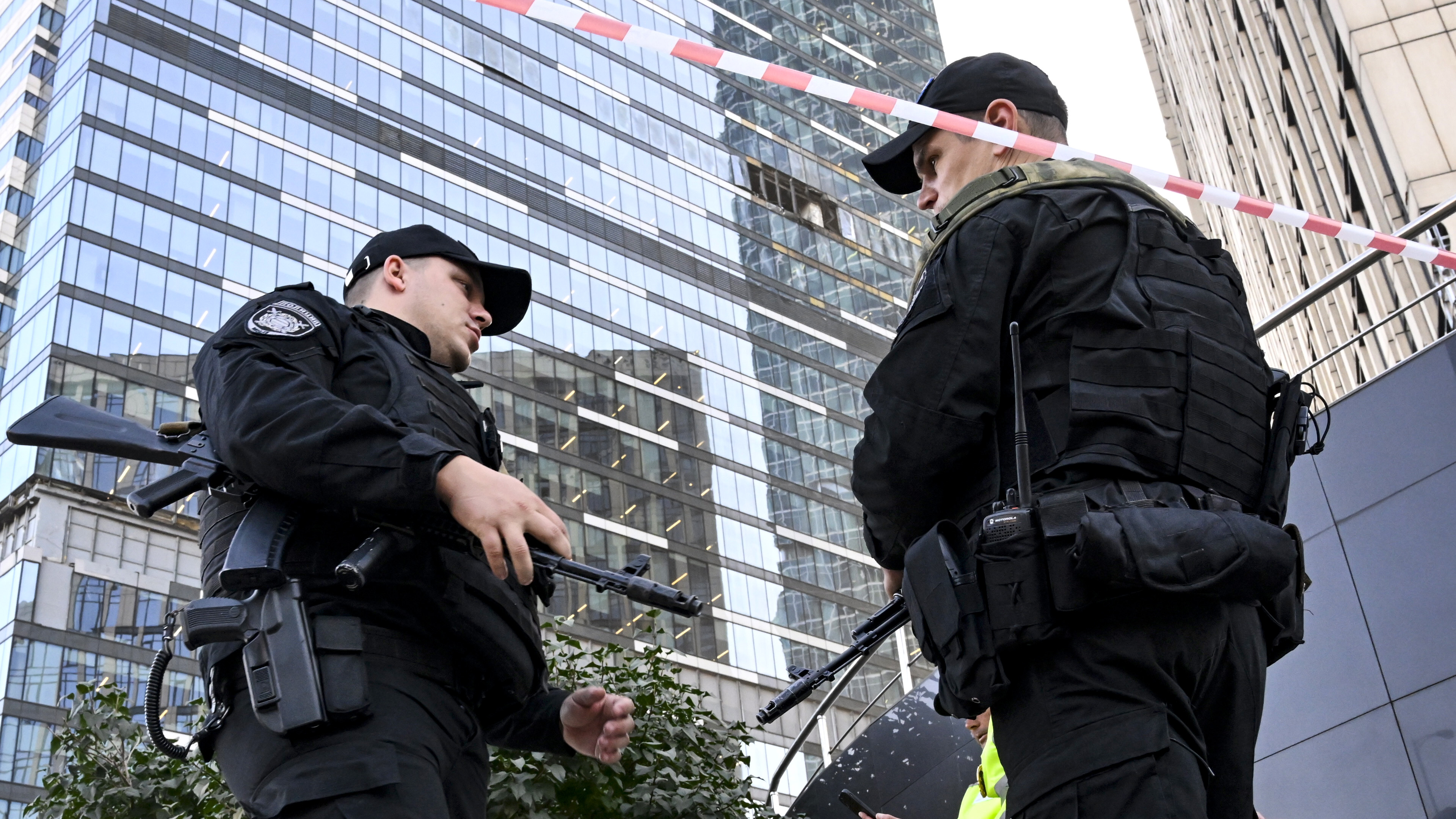 Police officers block off an area around a damaged office block of the Moscow International Business Center