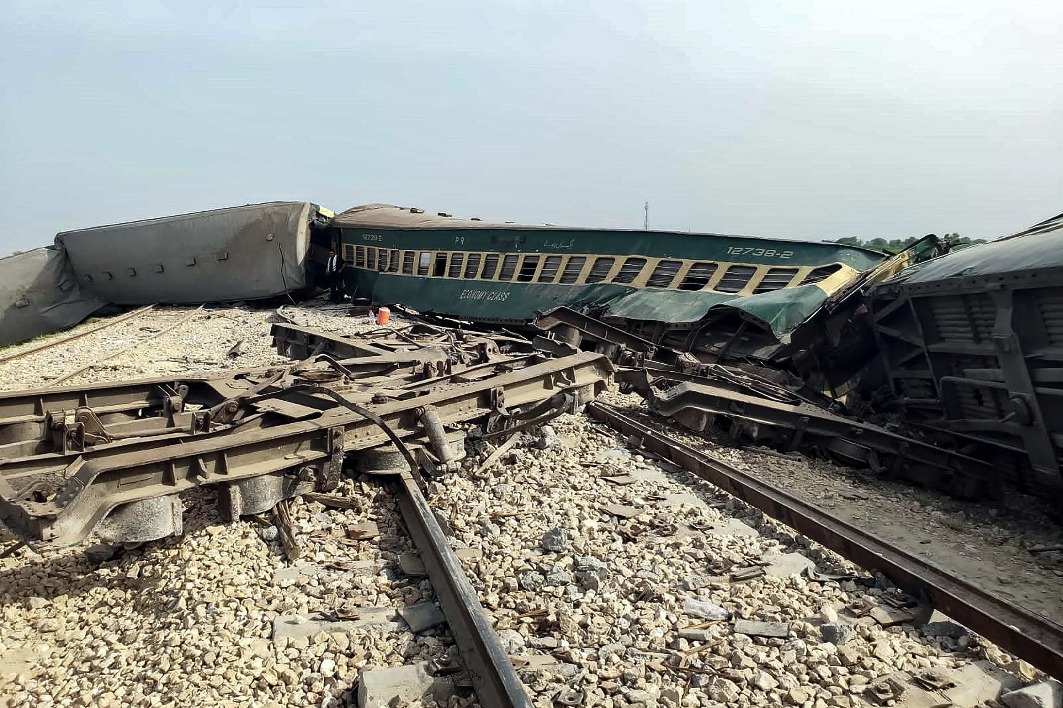 Damaged carriages are pictured following the derailment of the passenger train in Nawabshah, Pakistan [AFP]