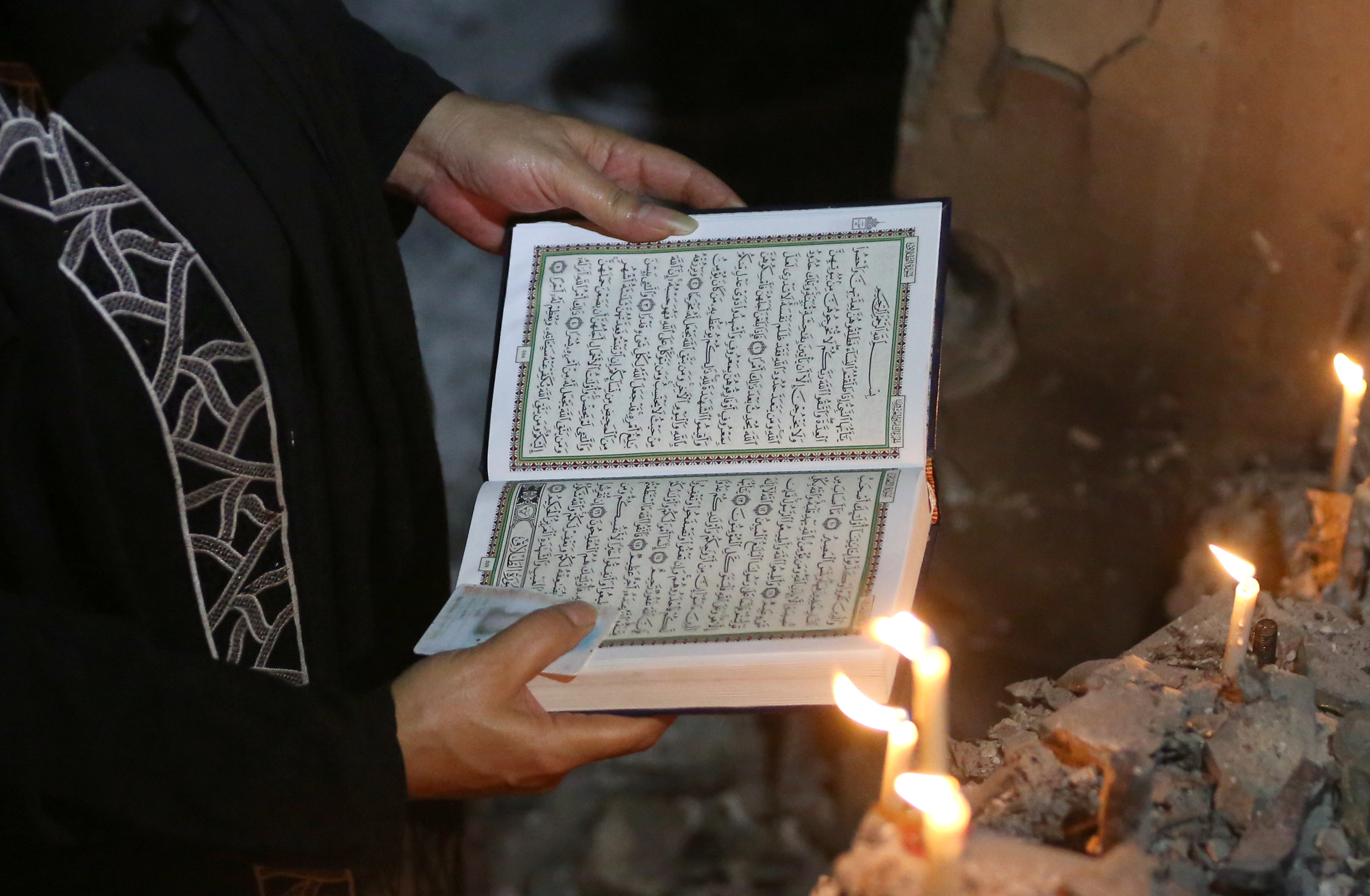 A woman reads the Quran, Islam's holy book