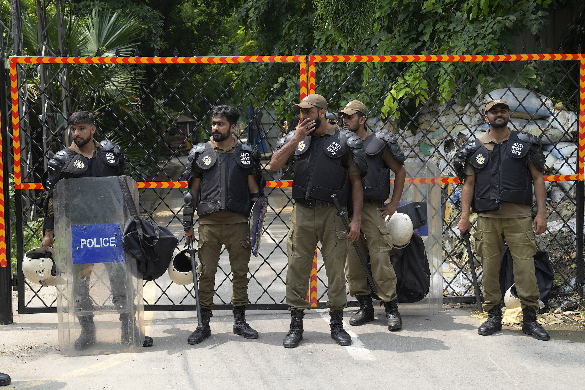 Police officers stand guard outside the residence of Pakistan's former Prime Minister Imran Khan, in Lahore, Pakistan.