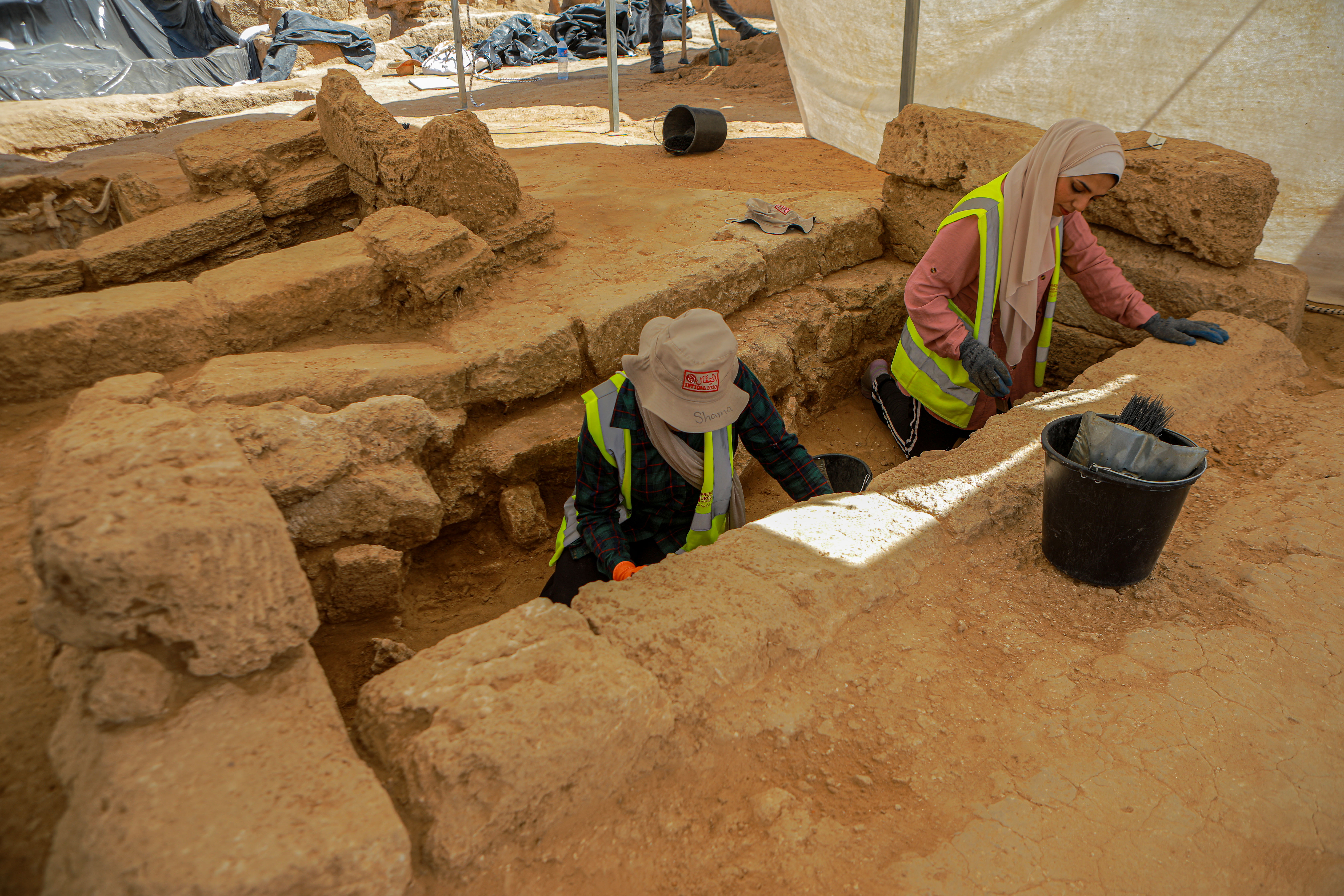 Young women working as part of the excavation and excavation team in the Roman cemetery discovered last year in northwest Gaza City [Abdelhakim Abu Riash, Al Jazeera]