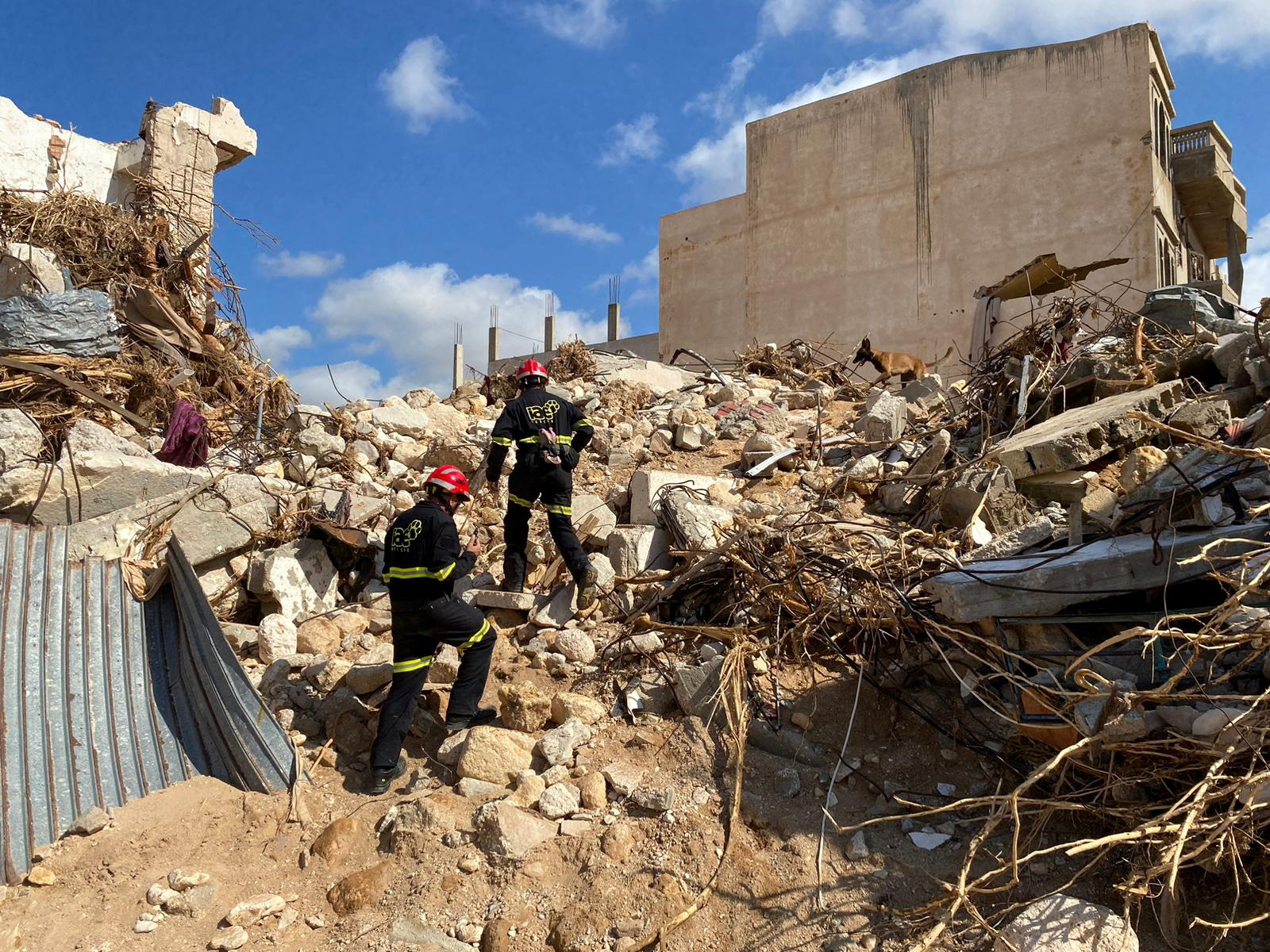 Rescue members from the NGO IAE work in the aftermath of a powerful storm and heavy rainfall,
